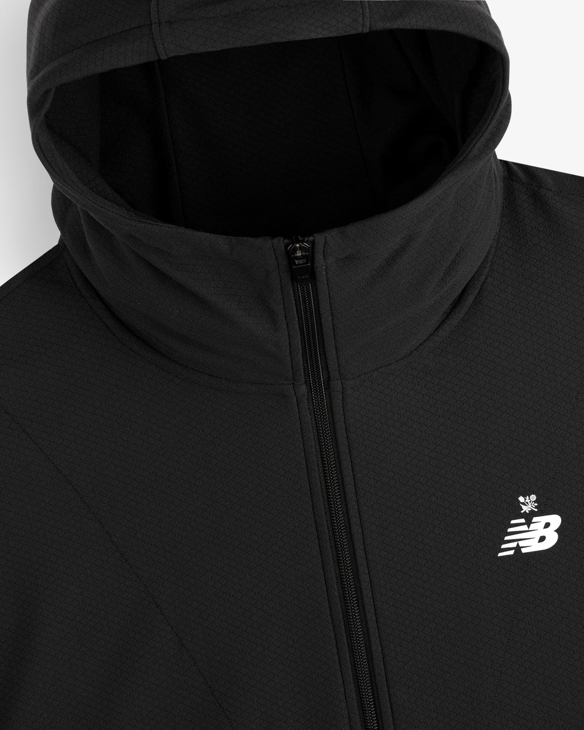 Close-up of the ALD / New Balance Full-Zip Warmup Hoodie in black with a white New Balance logo on the chest.
