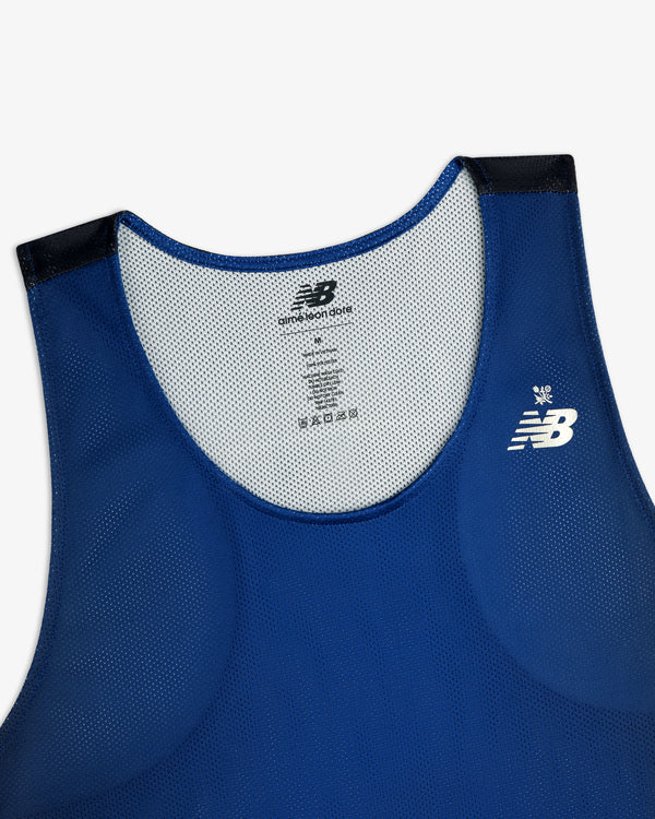 Blue ALD/New Balance Running Gradient Singlet with white logo and black shoulder accents, upper front view.