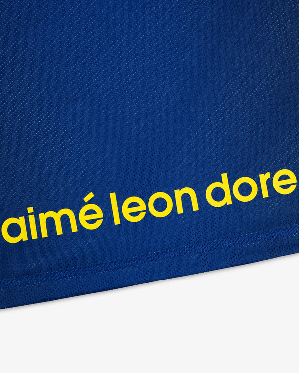 Blue ALD / New Balance Running Gradient Singlet with bold yellow “aimé leon dore” text near the hem.