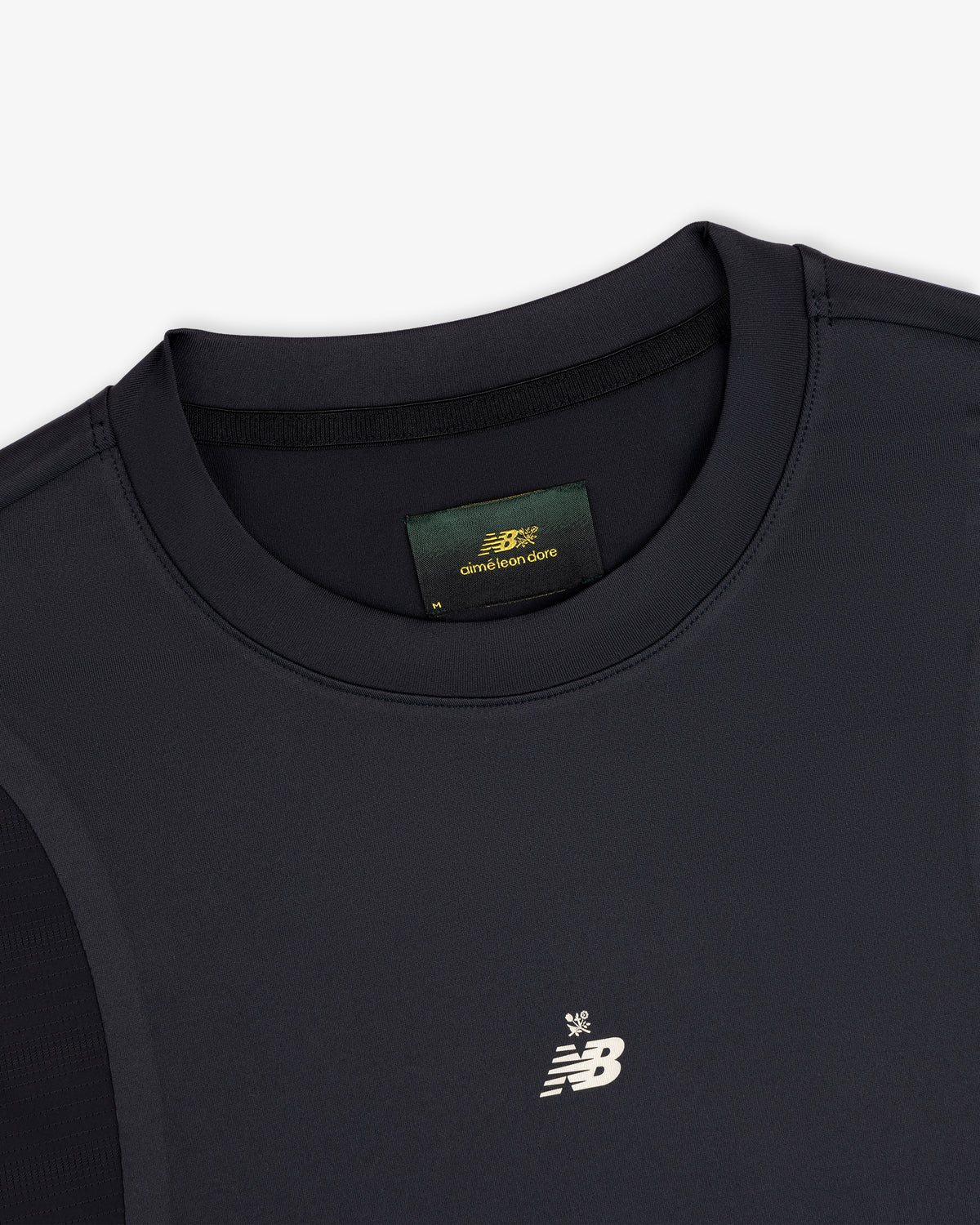 Close-up of a black ALD / New Balance Performance Long-Sleeve Tee with white logo and green label inside the collar.