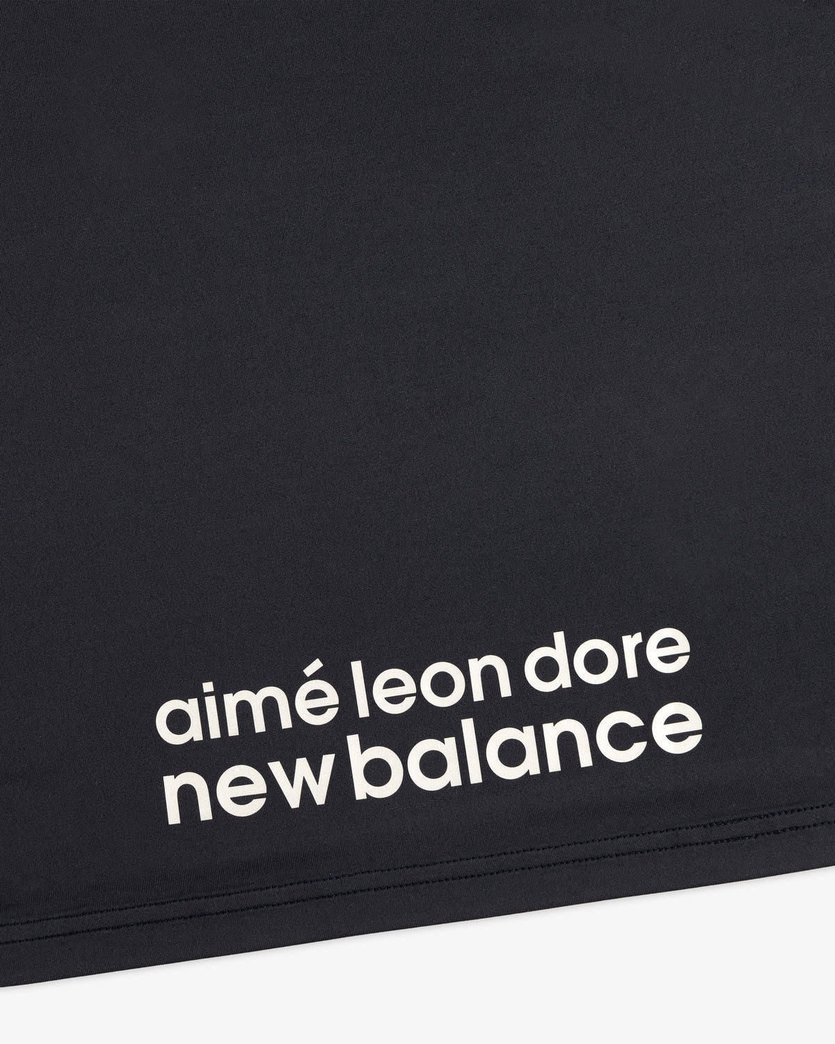 Black ALD / New Balance Performance Long-Sleeve Tee with white lowercase text in a modern font.