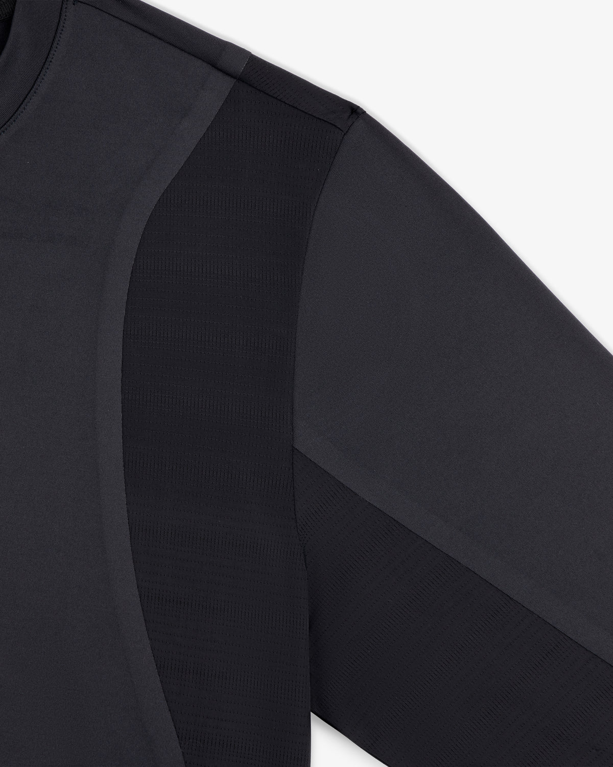 Close-up of ALD / New Balance Performance Long-Sleeve Tee showing fabric texture and seam details on shoulder and sleeve.