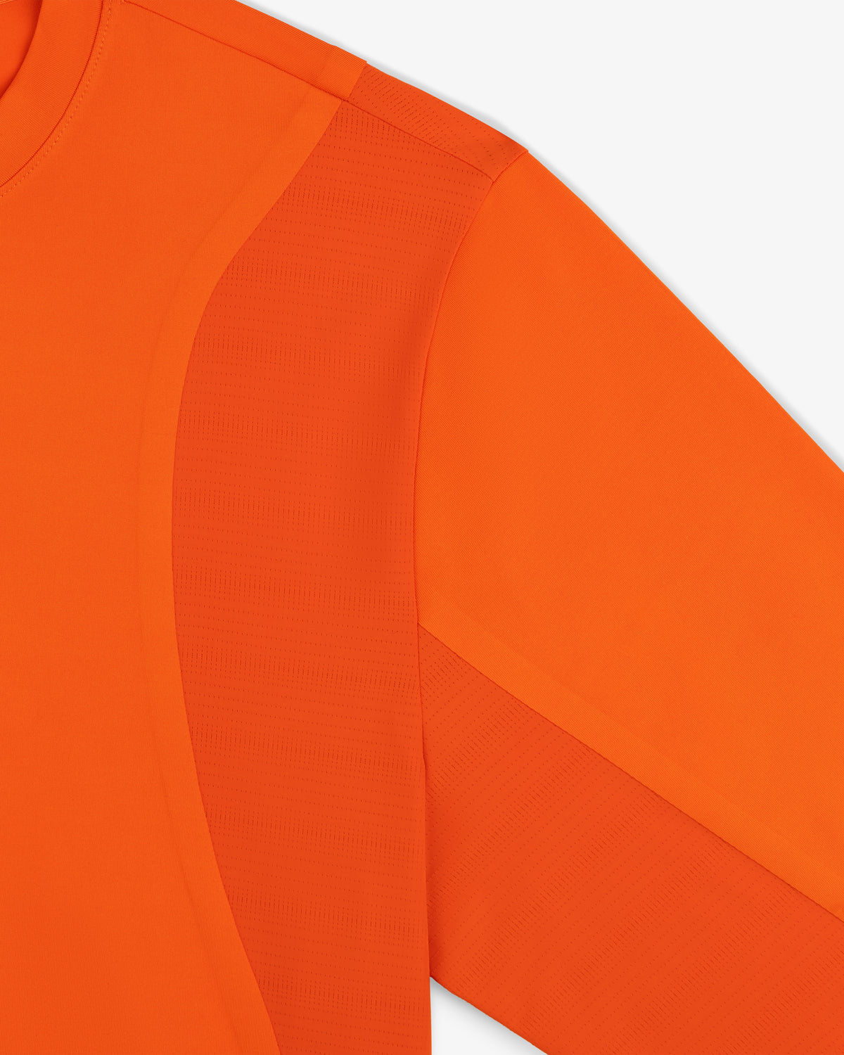 Close-up of the ALD / New Balance Performance Long-Sleeve Tee with textured fabric and seam details on a white background.
