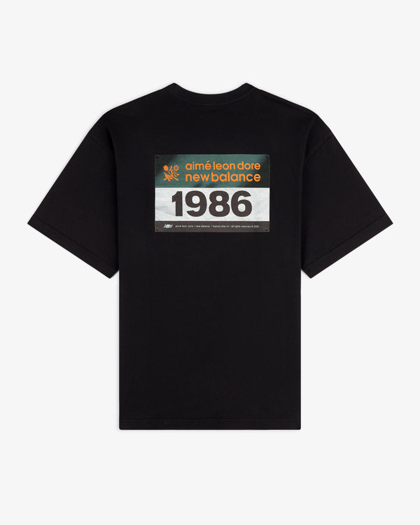 ALD / New Balance Running Bib Tee features a black color and racing bib graphic printed on the back.