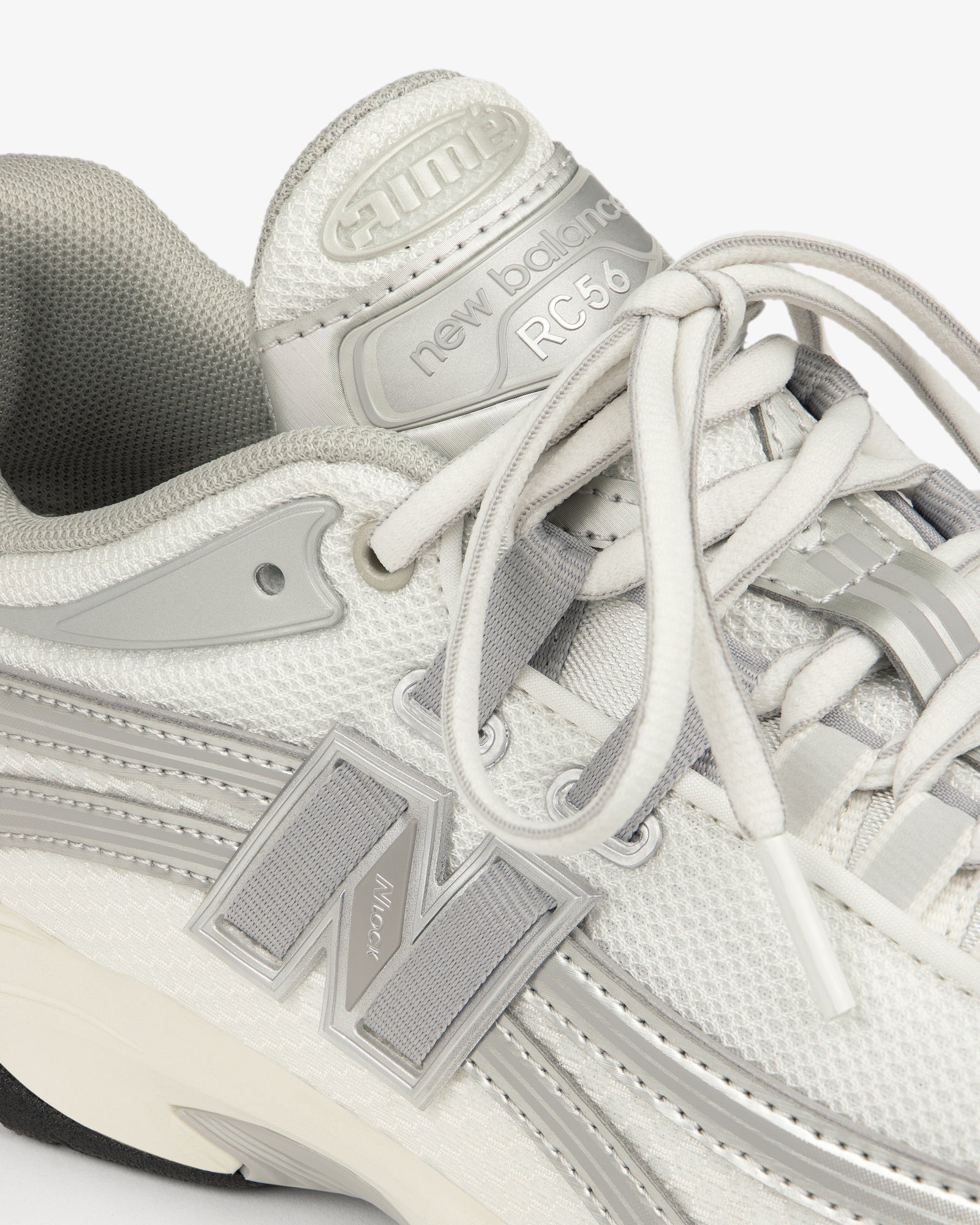 Close-up of a white and gray ALD / New Balance RC56 with FuelCell midsole and visible logo.