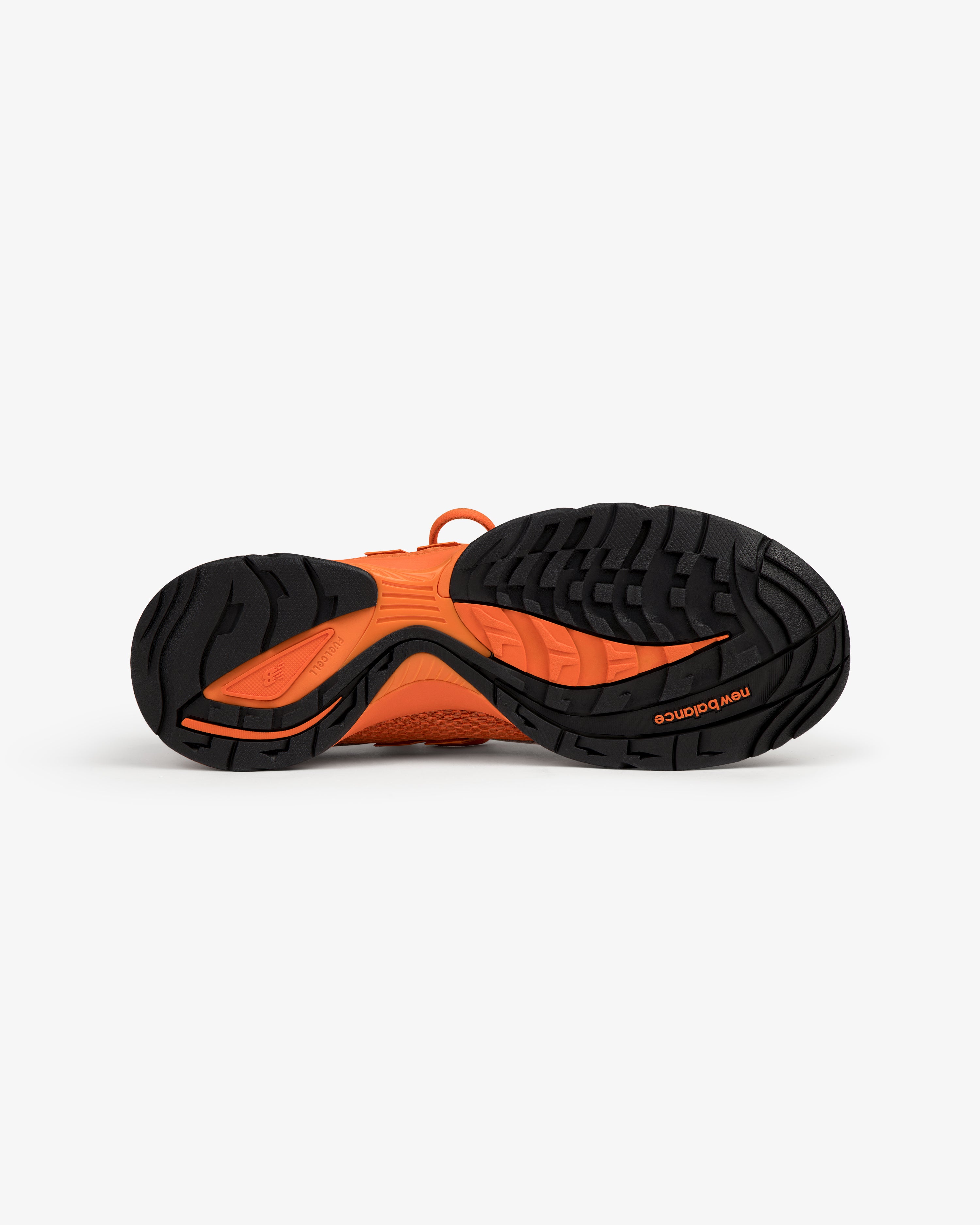 ALD / New Balance RC56 orange and black sole with textured tread, viewed from below.