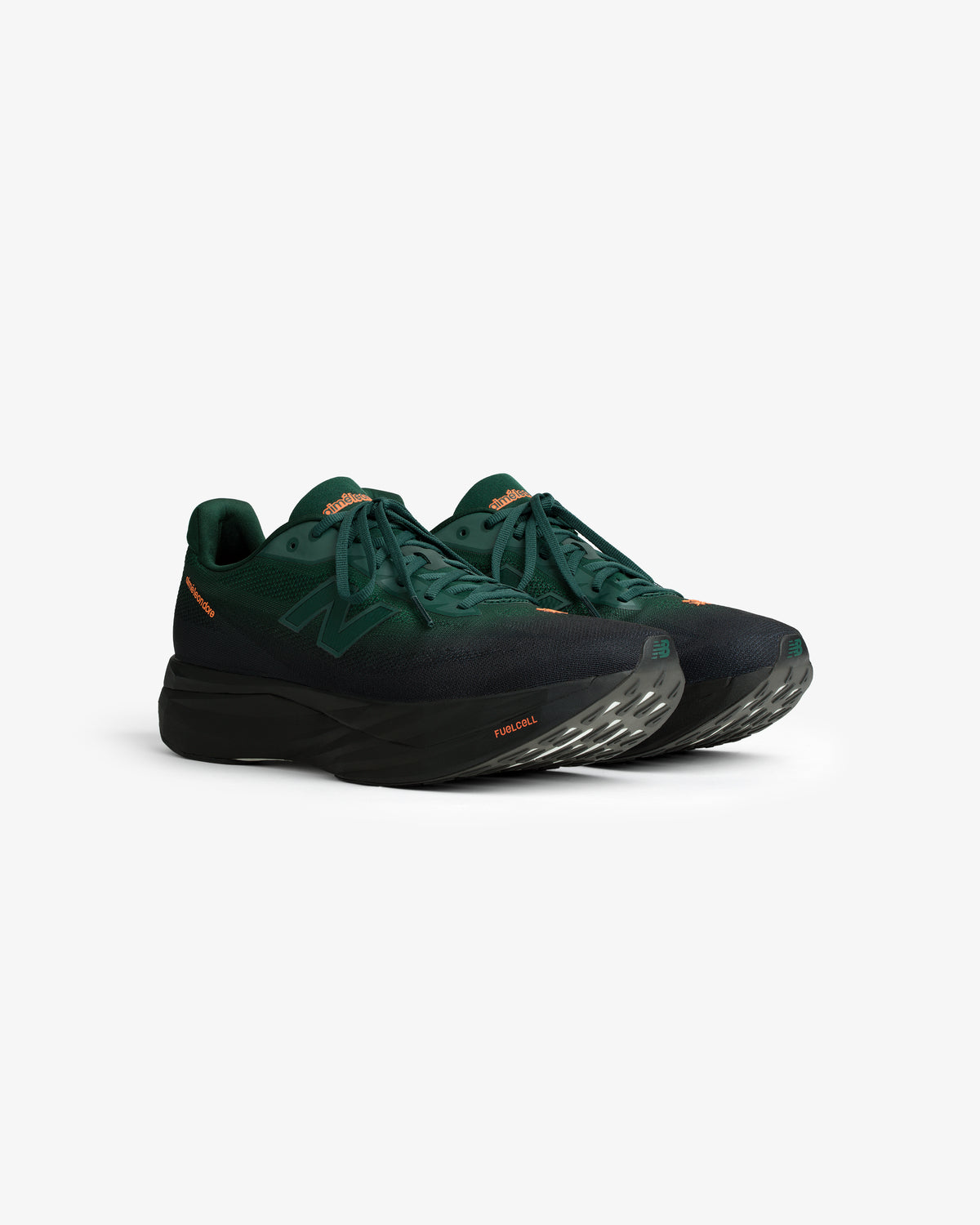 ALD/New Balance FuelCell SuperComp Elite v5 in dark green with black soles and orange accents on a white background.