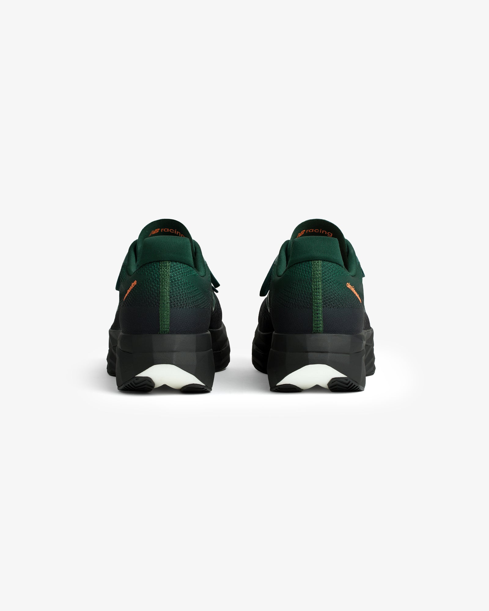 A pair of ALD / New Balance FuelCell SuperComp Elite v5 shoes in green and black, viewed from the back on white.