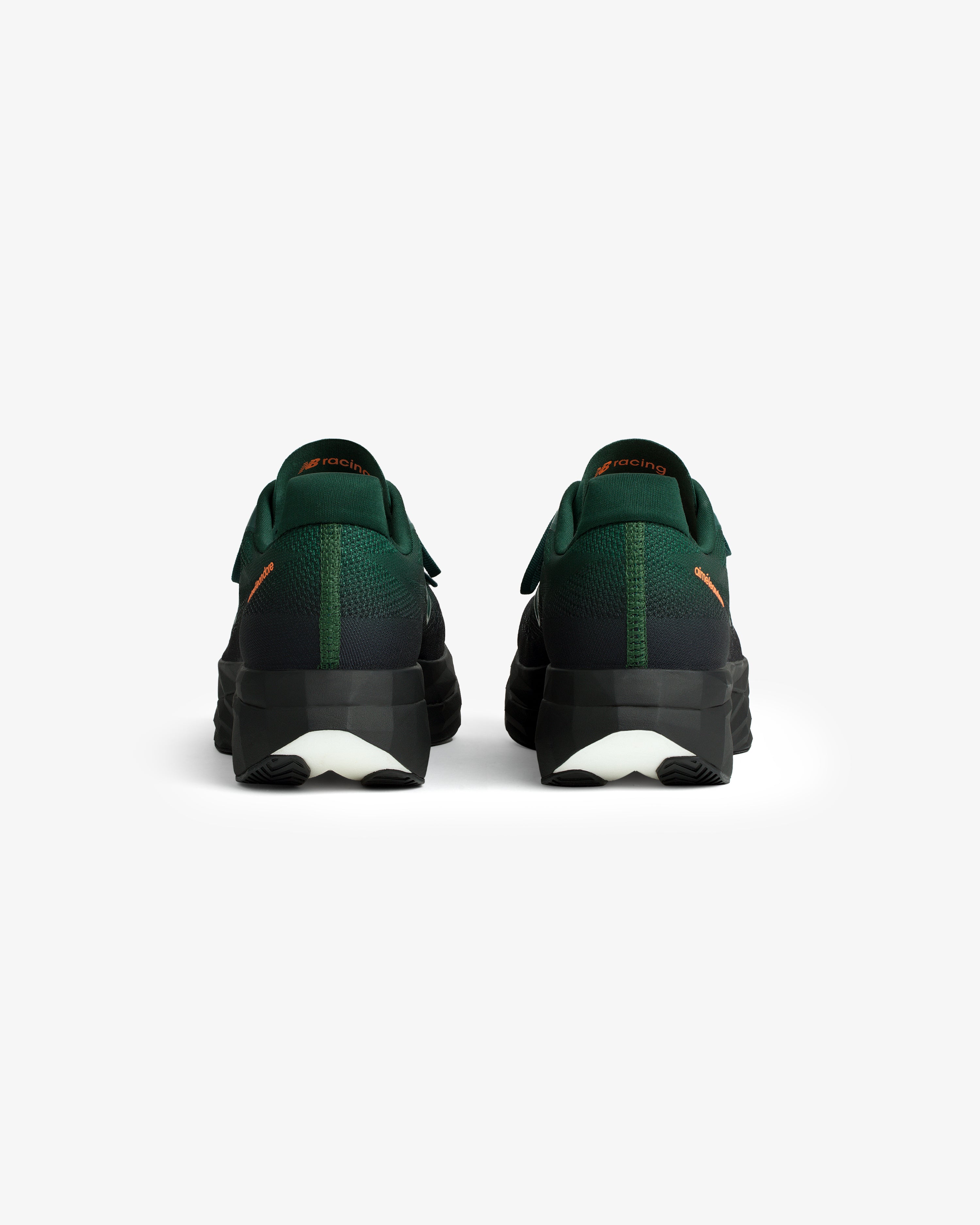 A pair of ALD / New Balance FuelCell SuperComp Elite v5 shoes in green and black, viewed from the back on white.