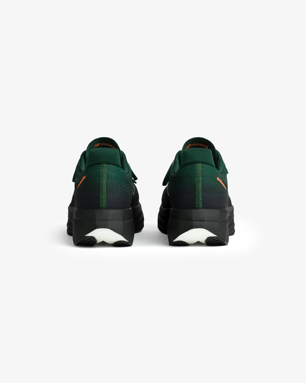 A pair of ALD / New Balance FuelCell SuperComp Elite v5 shoes in green and black, viewed from the back on white.