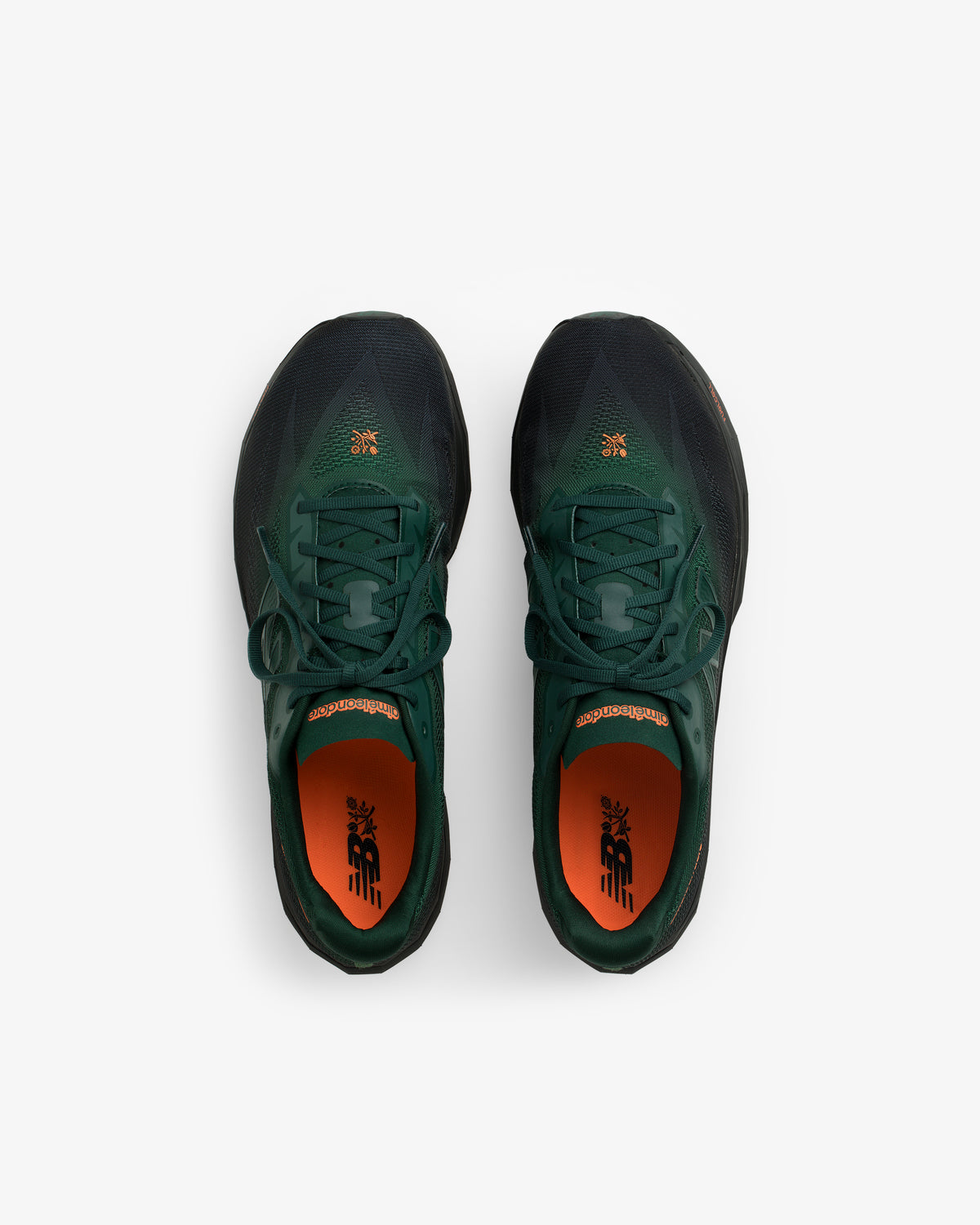 ALD / New Balance FuelCell SuperComp Elite v5 in dark green and black with orange insoles, top view on white.
