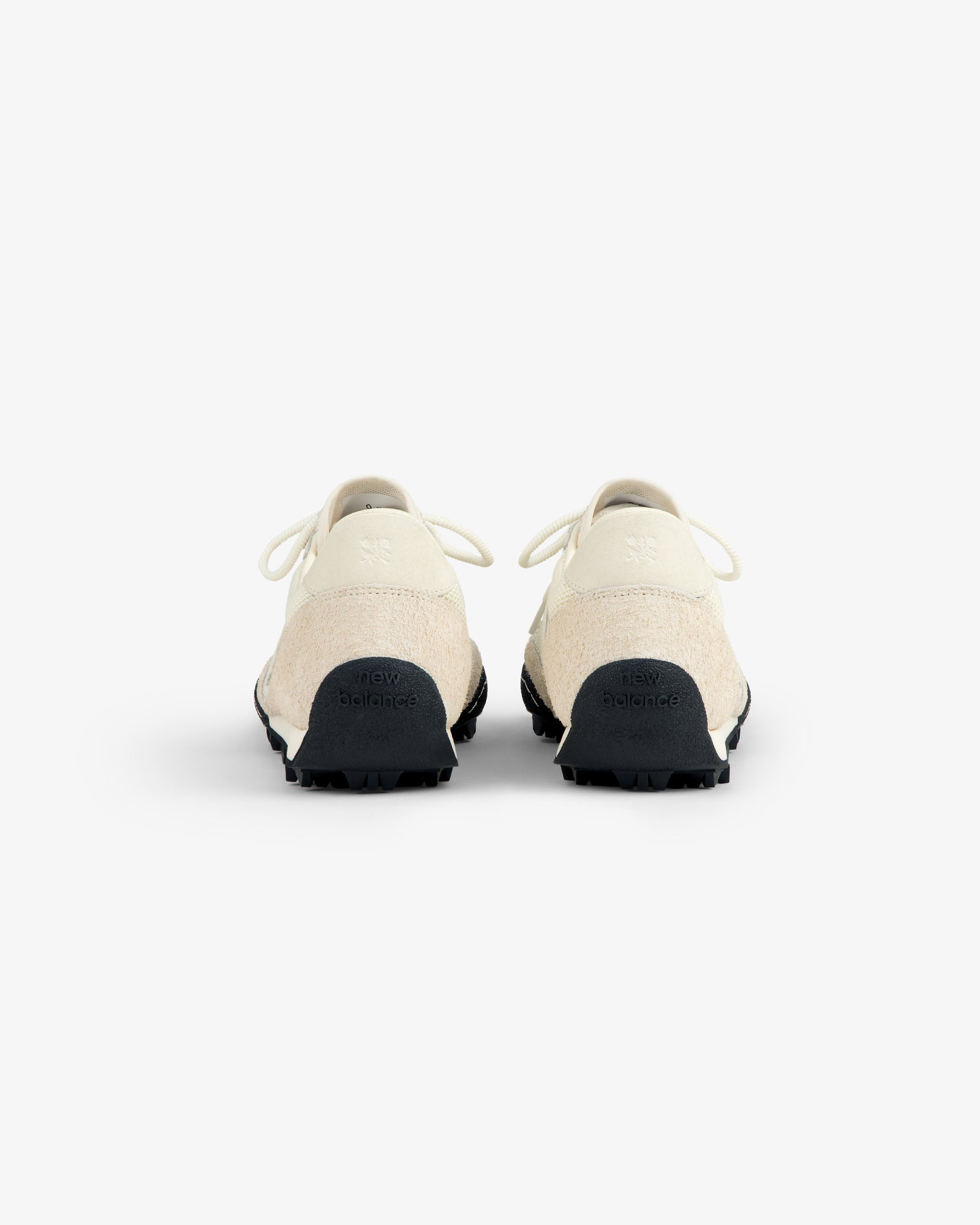 A pair of ALD / New Balance Gator sneakers in off-white, shown from the back against a white background.