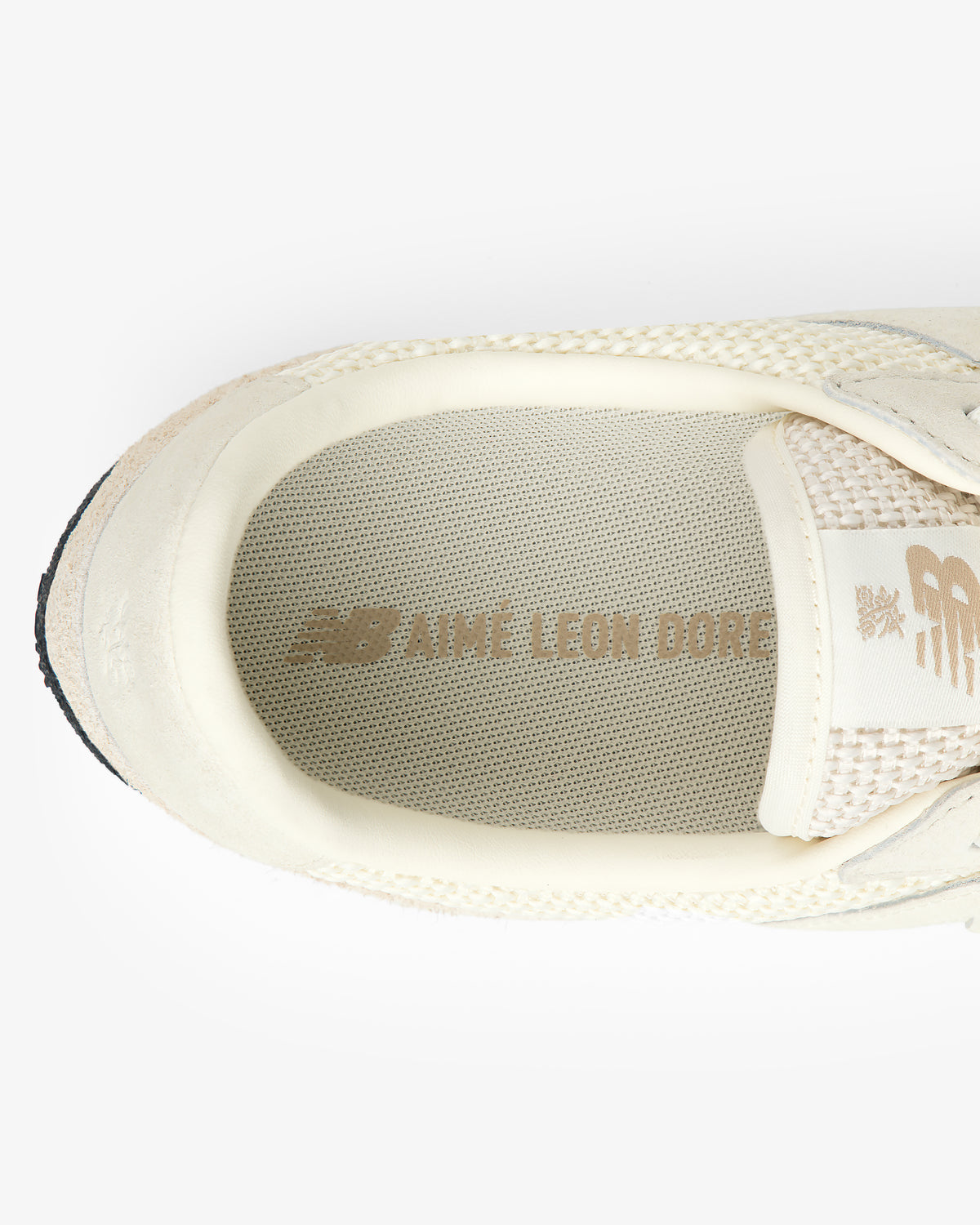 Cream-colored ALD / New Balance Gator sneaker with branded insole, viewed from above.