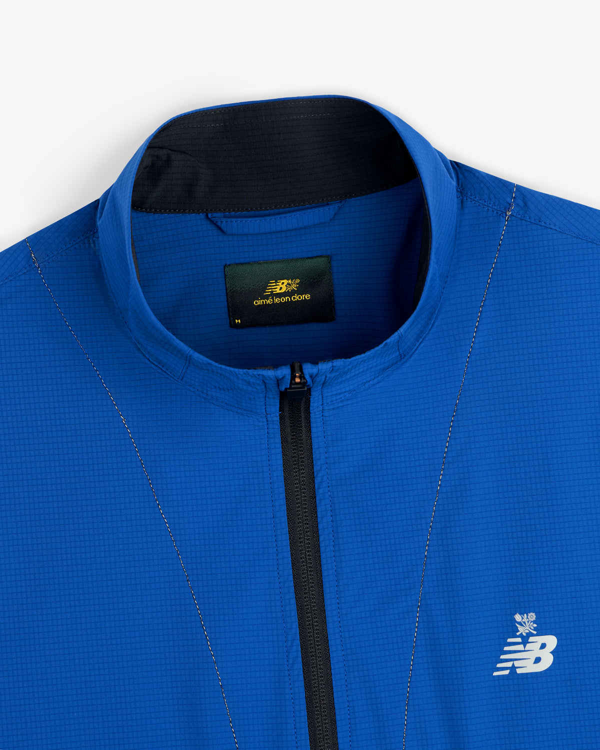 Bright blue ALD / New Balance Performance Nylon Jacket with zip front, collar, chest logo, and neck label.