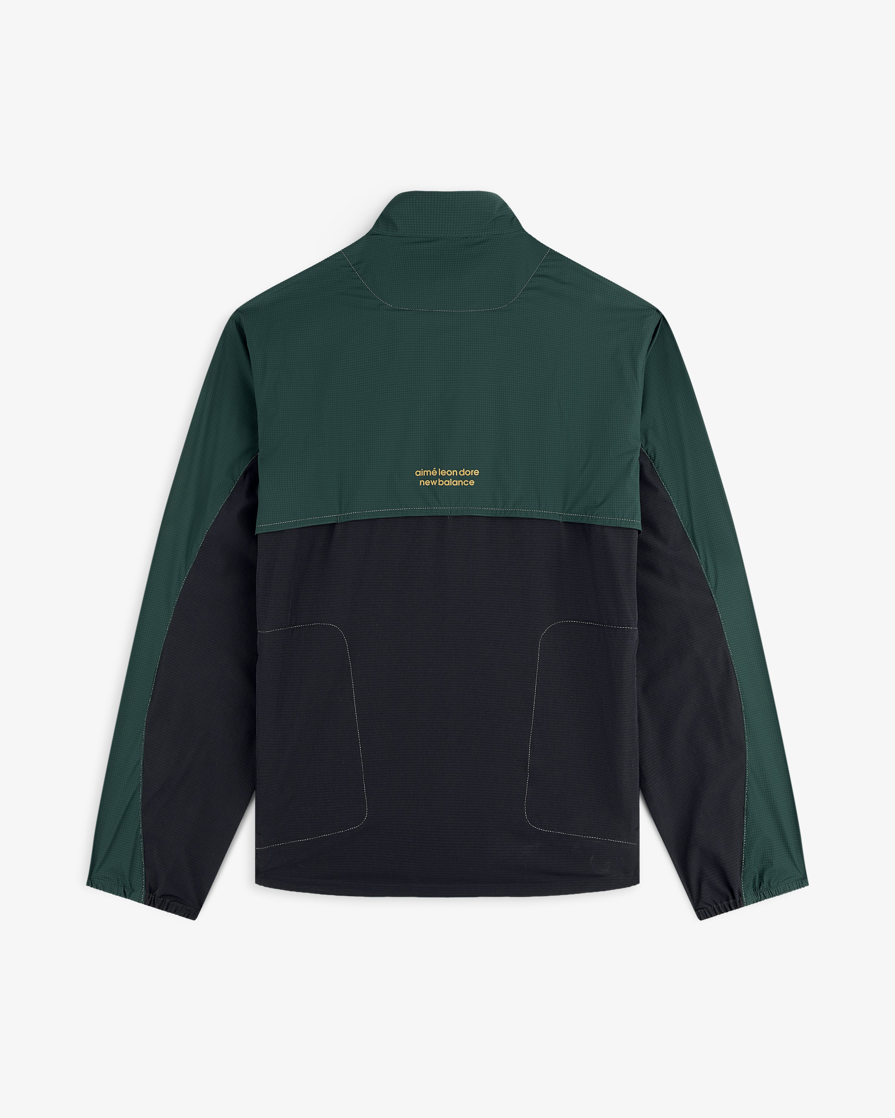 ALD / New Balance Performance Nylon Jacket with dark green sleeves/top, black bottom, and small yellow text on the back.