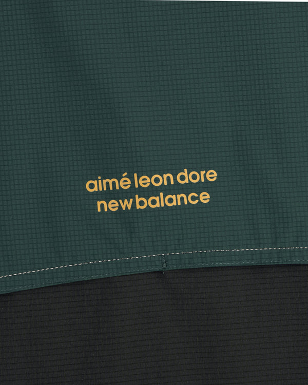 Close-up of the ALD / New Balance Performance Nylon Jacket in green and black with yellow branding.