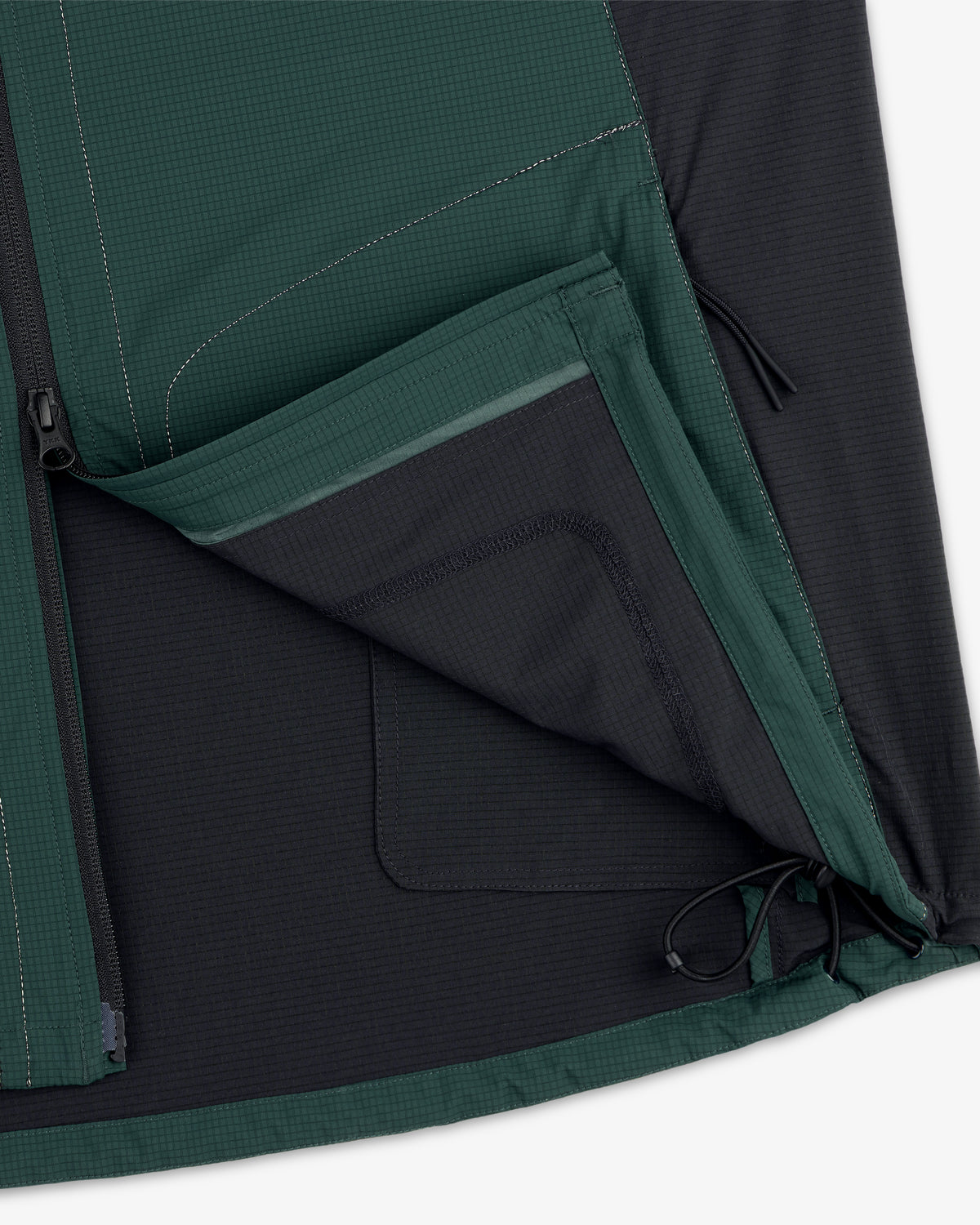Close-up of the ALD / New Balance Performance Nylon Jacket with open zippered pocket, mesh lining, and visible stitching.