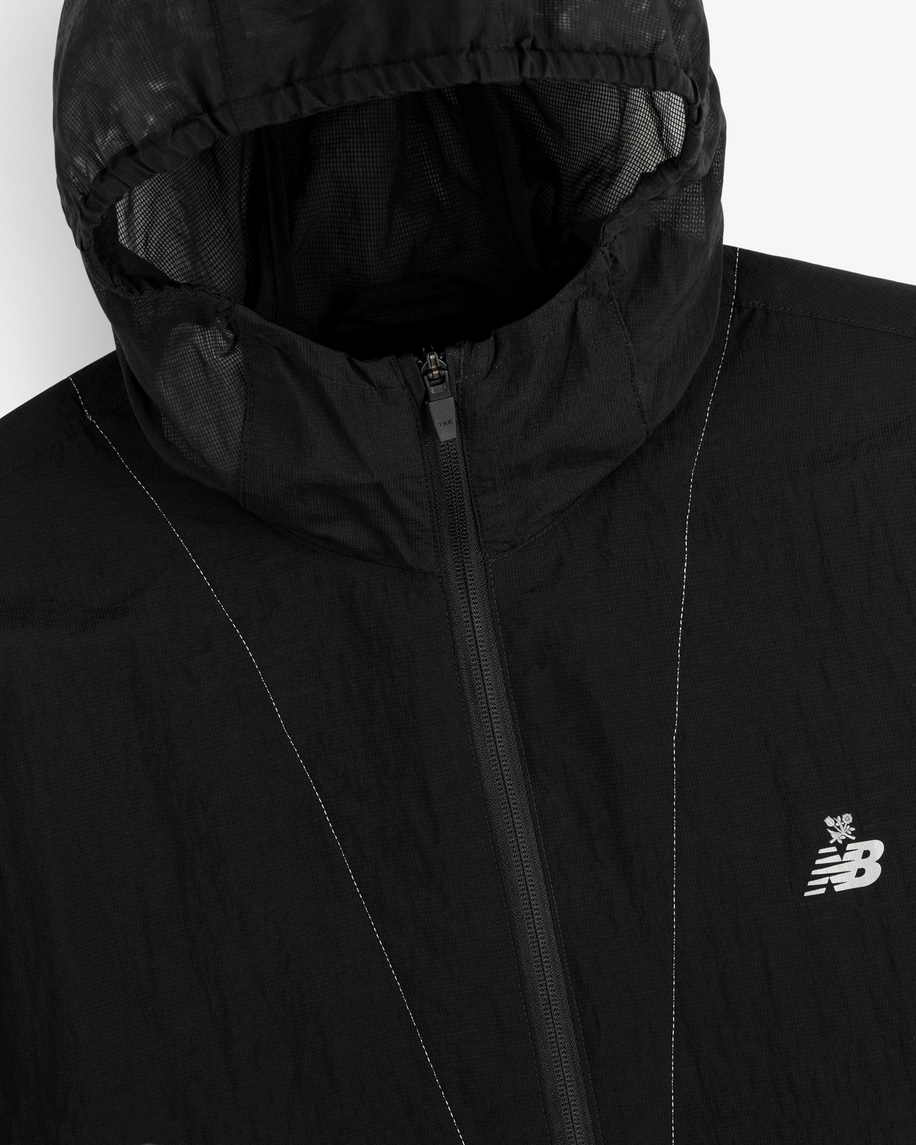 Black ALD / New Balance breathable half-zip pullover with hood and white logo on the left chest.