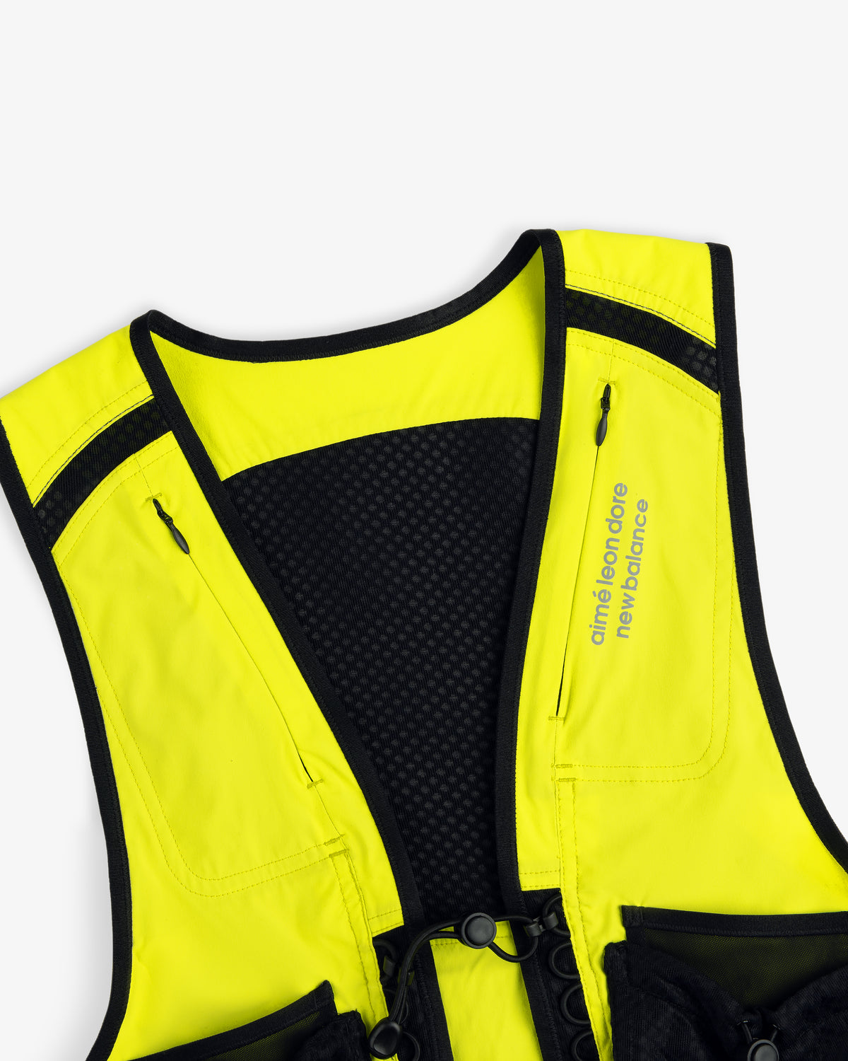 A close-up of the yellow and black ALD / New Balance Hydrovest with branding on the right chest.