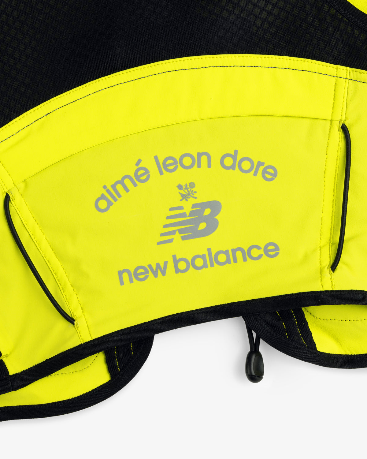 Close-up of the yellow ALD / New Balance Hydrovest featuring gray Aimé Leon Dore and New Balance logos.