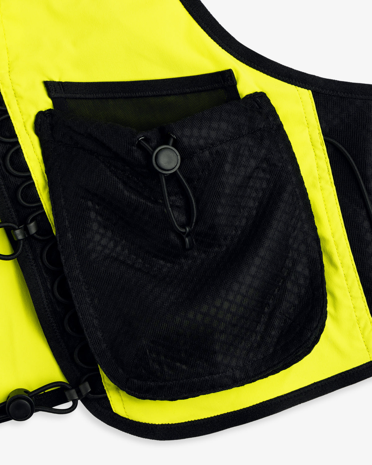 Close-up of the ALD / New Balance Hydrovest in yellow with a large black mesh pocket and drawstring toggle.