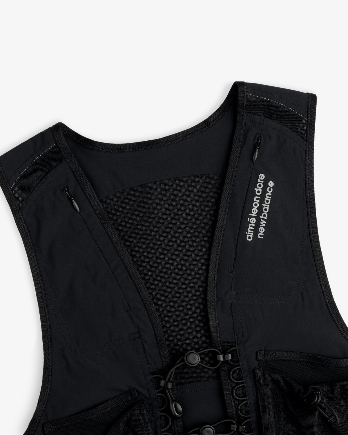 The ALD / New Balance Hydrovest features a mesh back and “aimé leon dore new balance” text on the left shoulder strap.