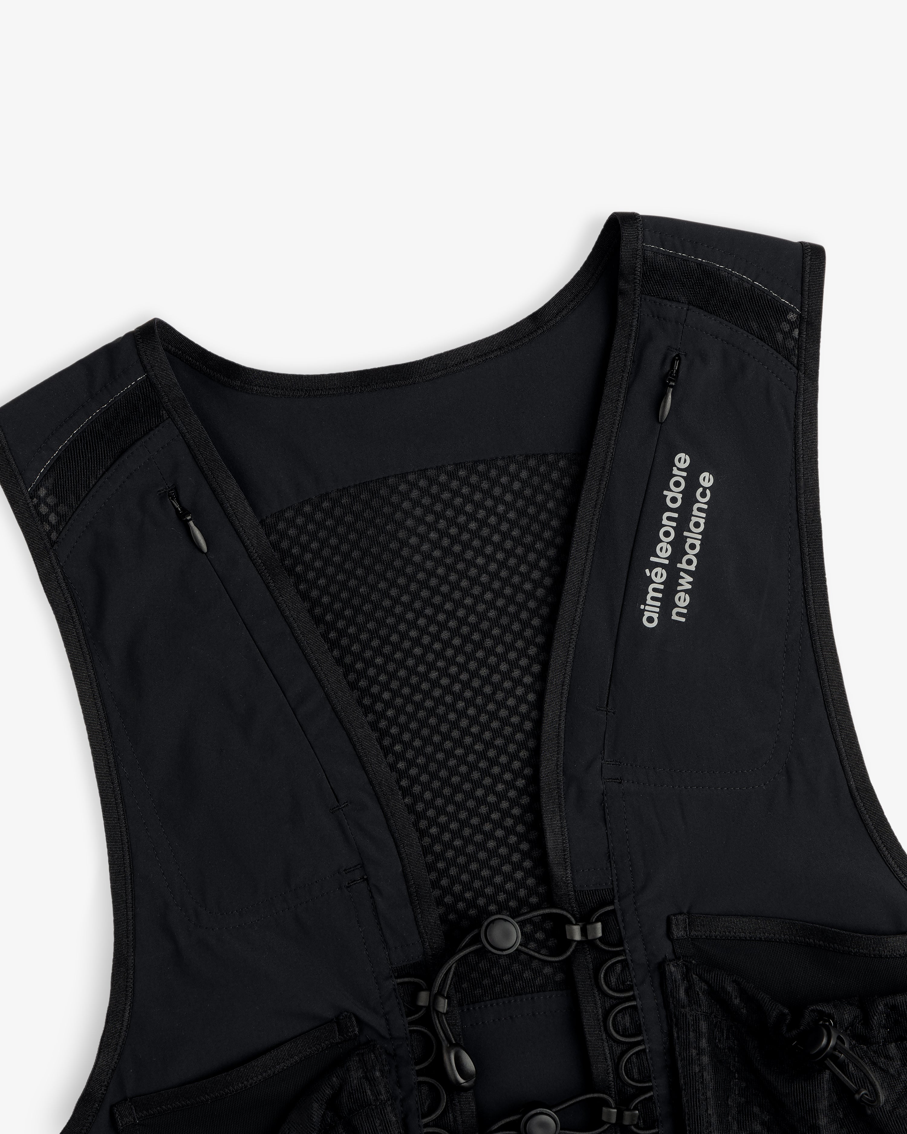 The ALD / New Balance Hydrovest features a mesh back and “aimé leon dore new balance” text on the left shoulder strap.