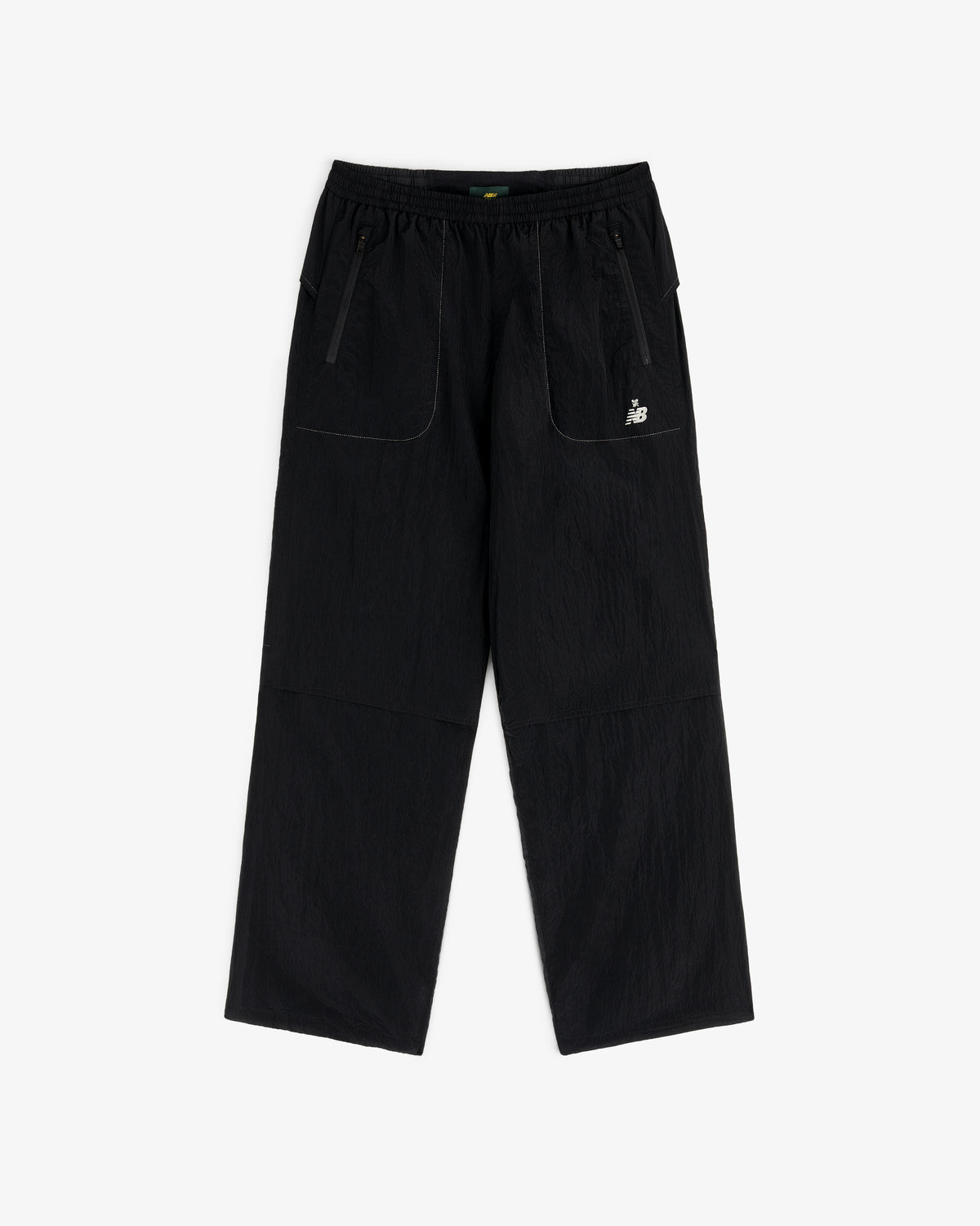 ALD / New Balance Lightweight Nylon Warmup Pant: black, straight-leg, elastic waist, front pockets, white logo.