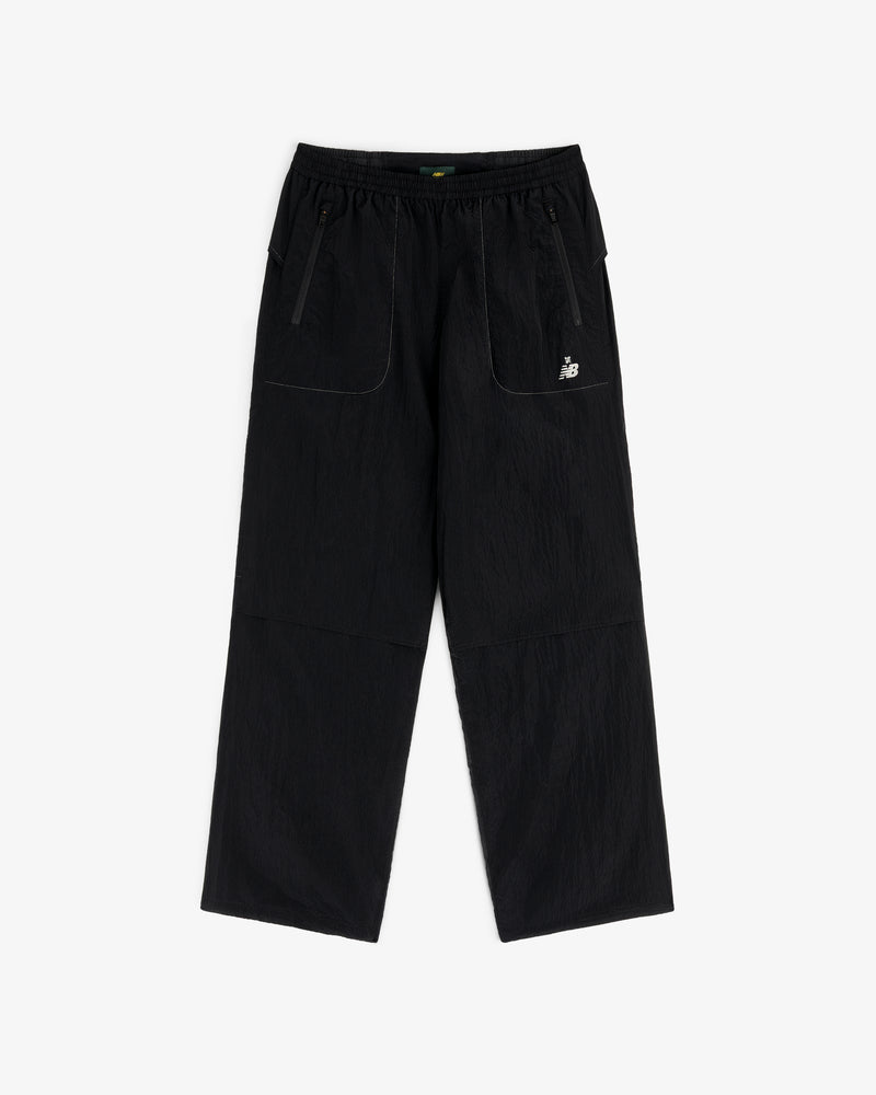 ALD / New Balance Lightweight Nylon Warmup Pant: black, straight-leg, elastic waist, front pockets, white logo.