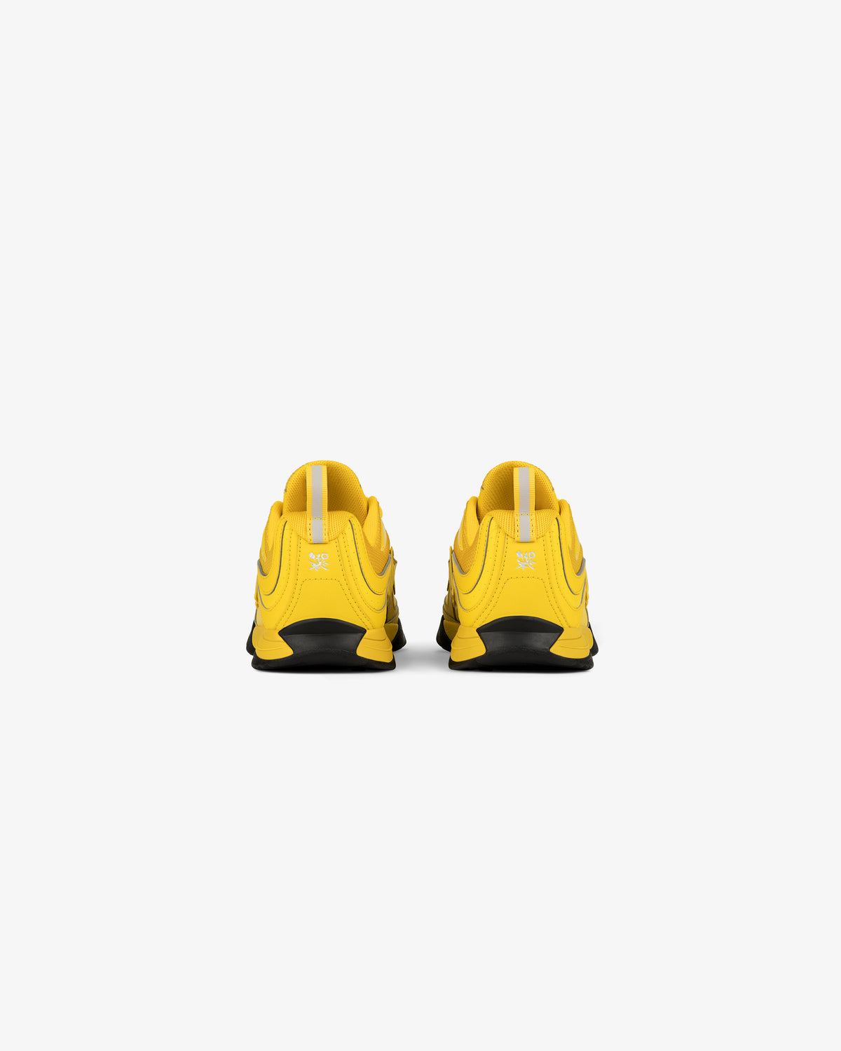 Back view of ALD / New Balance RC56 yellow athletic shoes with black soles on a white background.