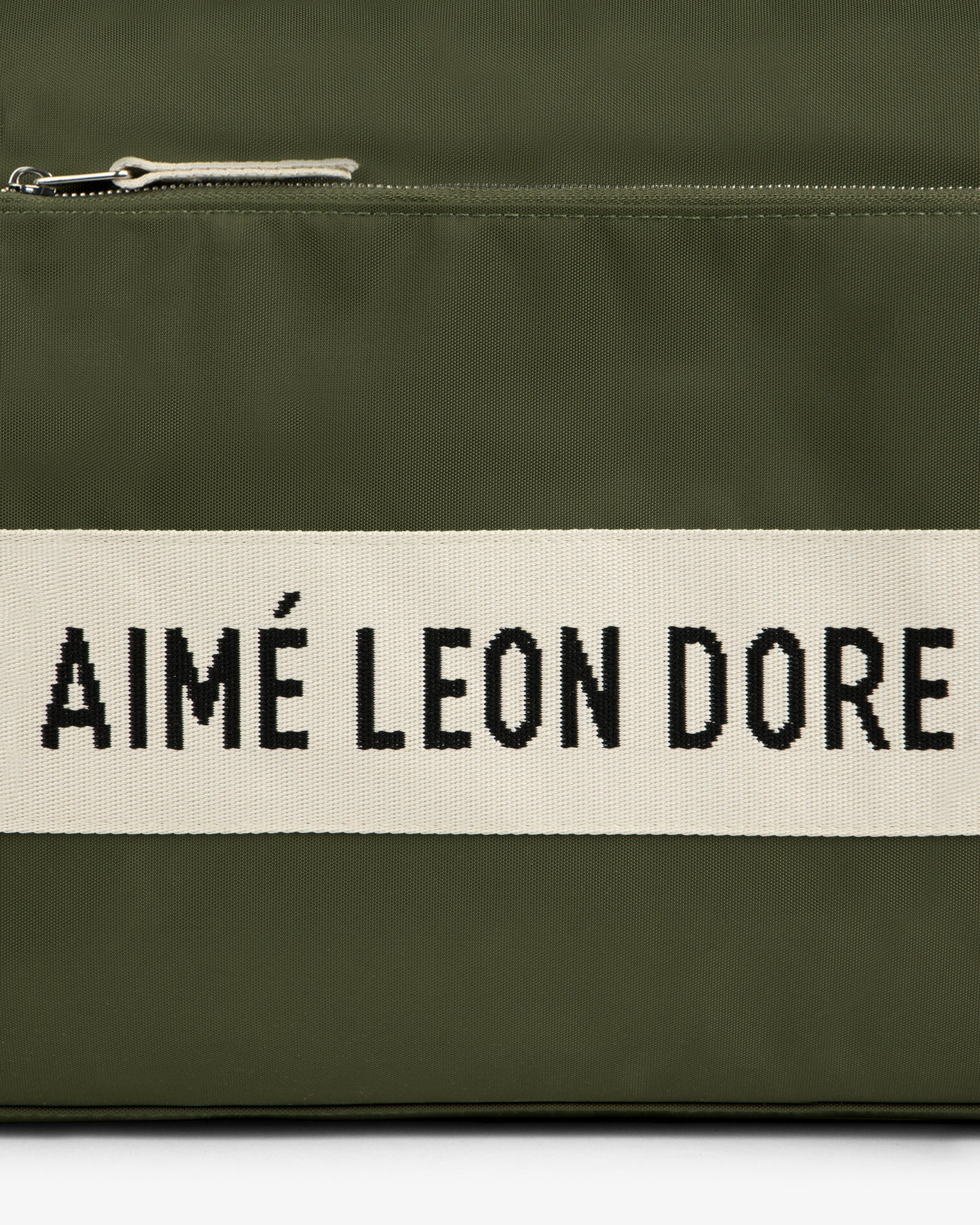 Olive green Nylon Duffle Bag with a white stripe featuring AIMÉ LEON DORE in bold black letters.