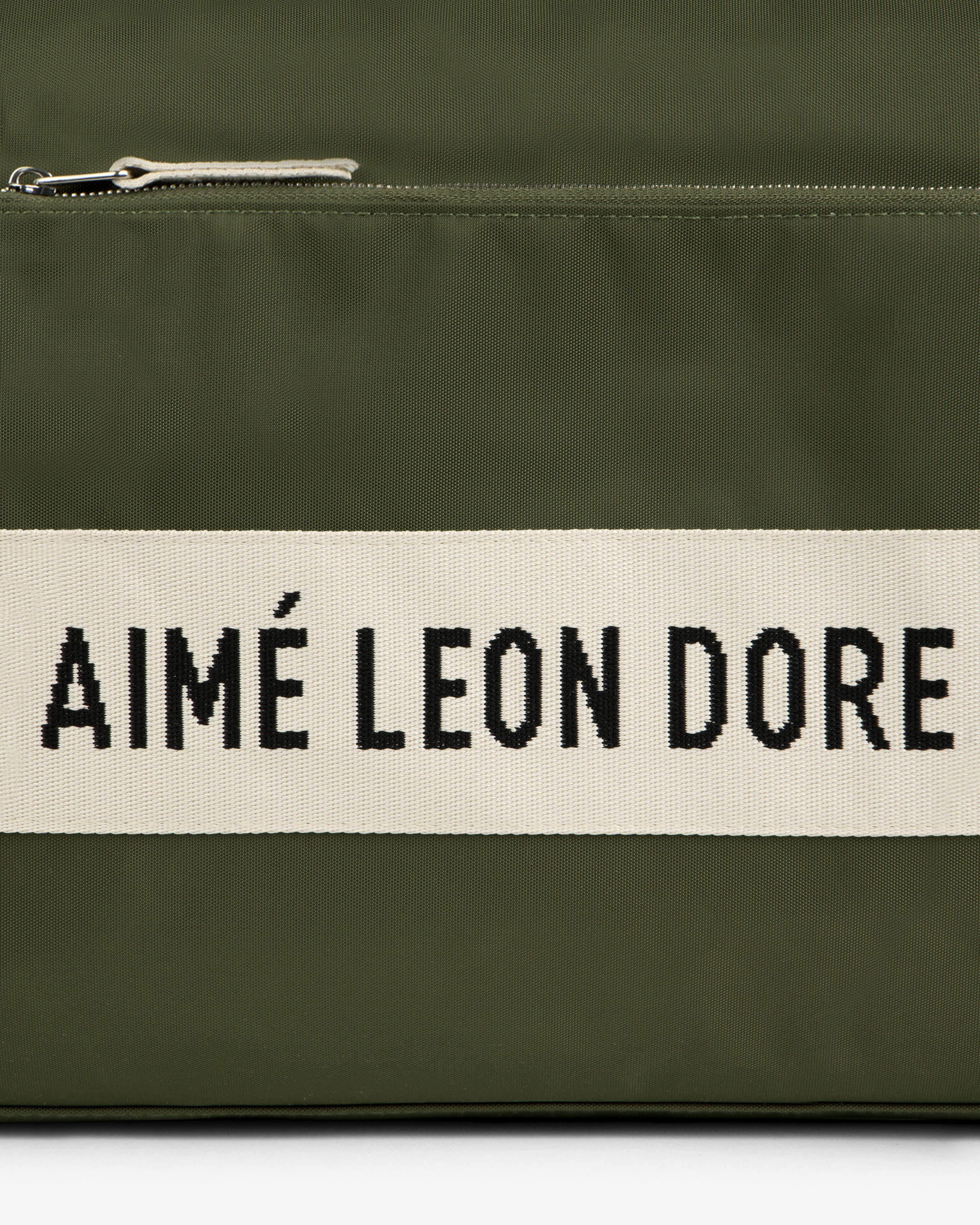 Olive green Nylon Duffle Bag with a white stripe featuring AIMÉ LEON DORE in bold black letters.