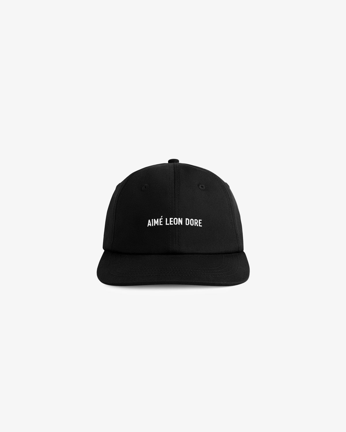 Core Logo Hat: Black baseball cap with AIMÉ LEON DORE text embroidered in white on the front, on a white background.