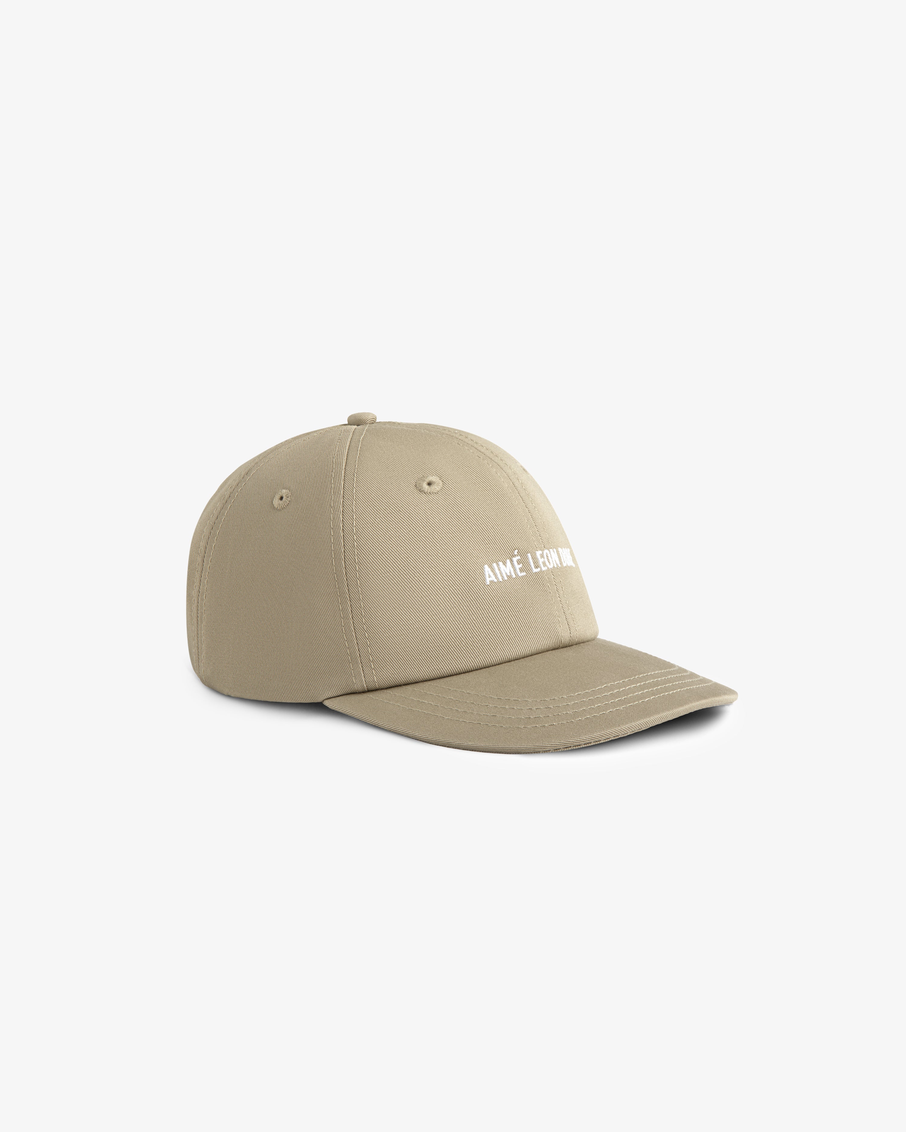 Core Logo Hat in beige with white AIMÉ LEON DORE text on front, displayed on a plain white background.