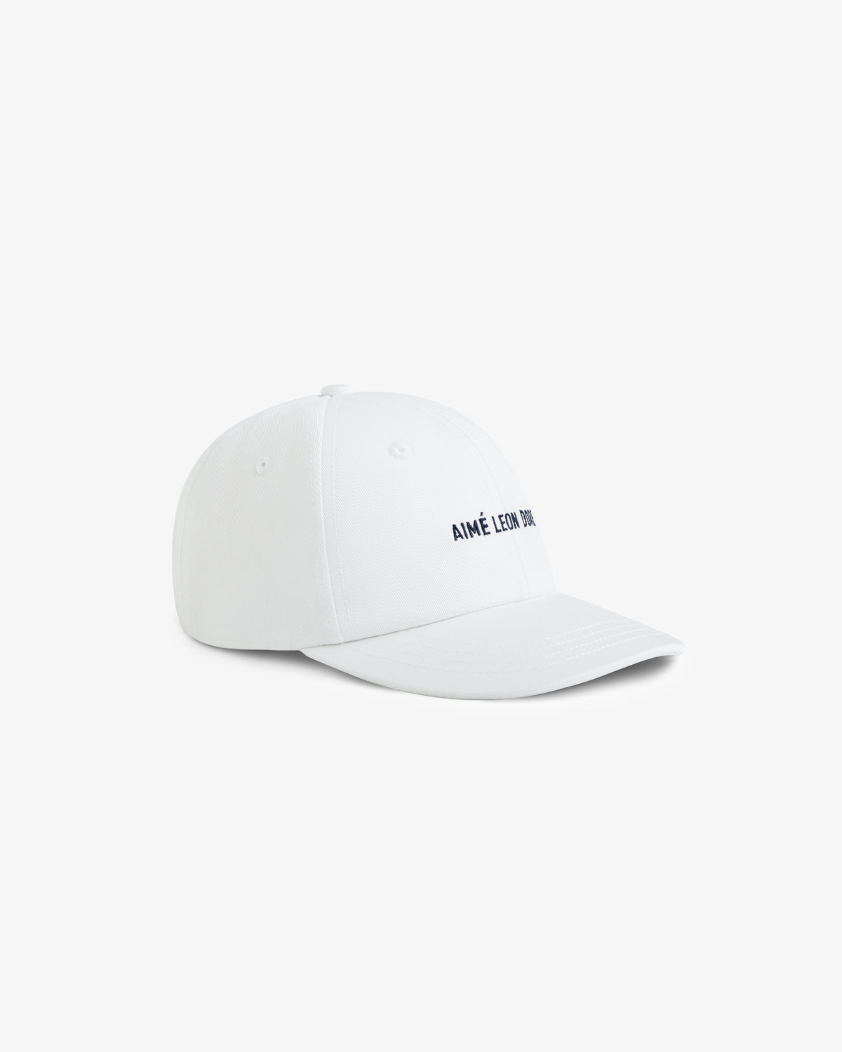 Core Logo Hat in white with small black AIMÉ LEON DORE text on the front, shown at an angle on a white background.