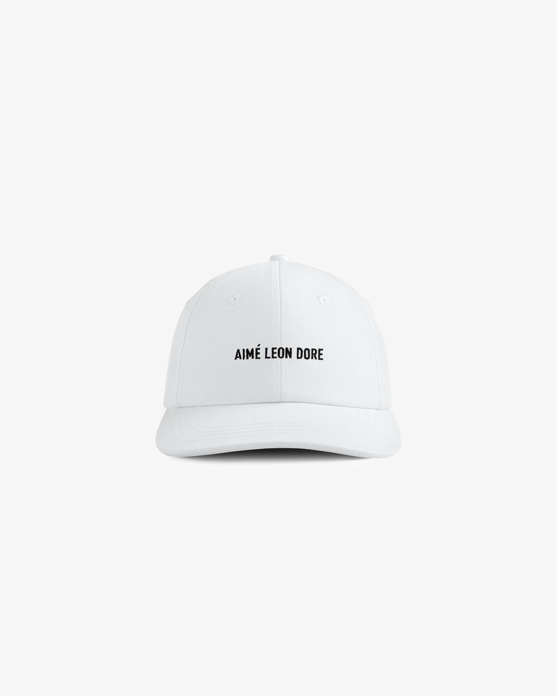 Core Logo Hat: white baseball cap with small black "AIMÉ LEON DORE" text centered on the front.