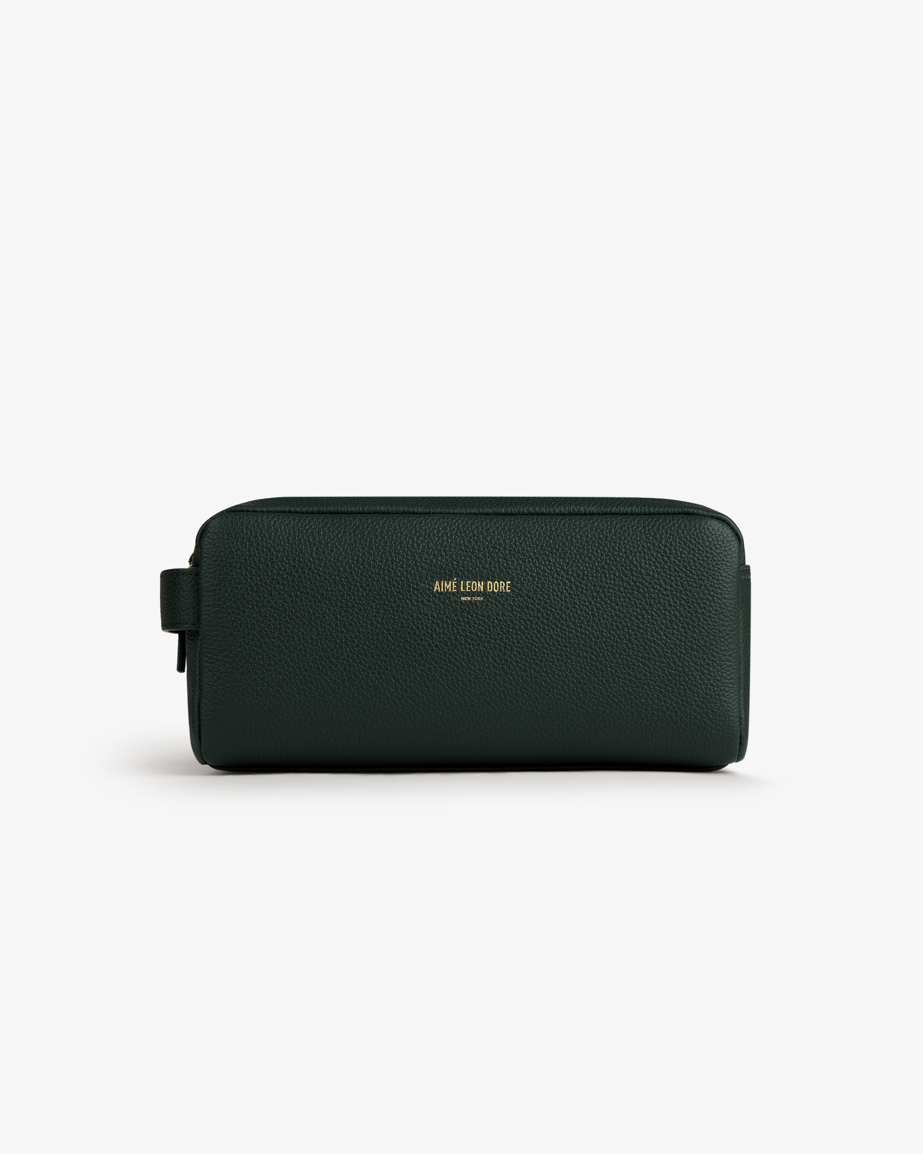 Dark green Leather Traveler Kit with gold AIME LEON DORE logo on front, shown against a white background.