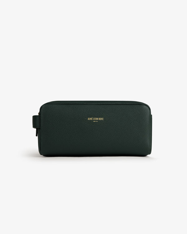 Dark green Leather Traveler Kit with gold AIME LEON DORE logo on front, shown against a white background.