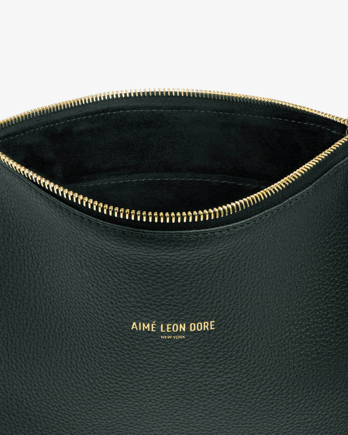 The Small Leather Pouch is black with a gold zipper and AIMÉ LEON DORE NEW YORK embossed in gold on the front.