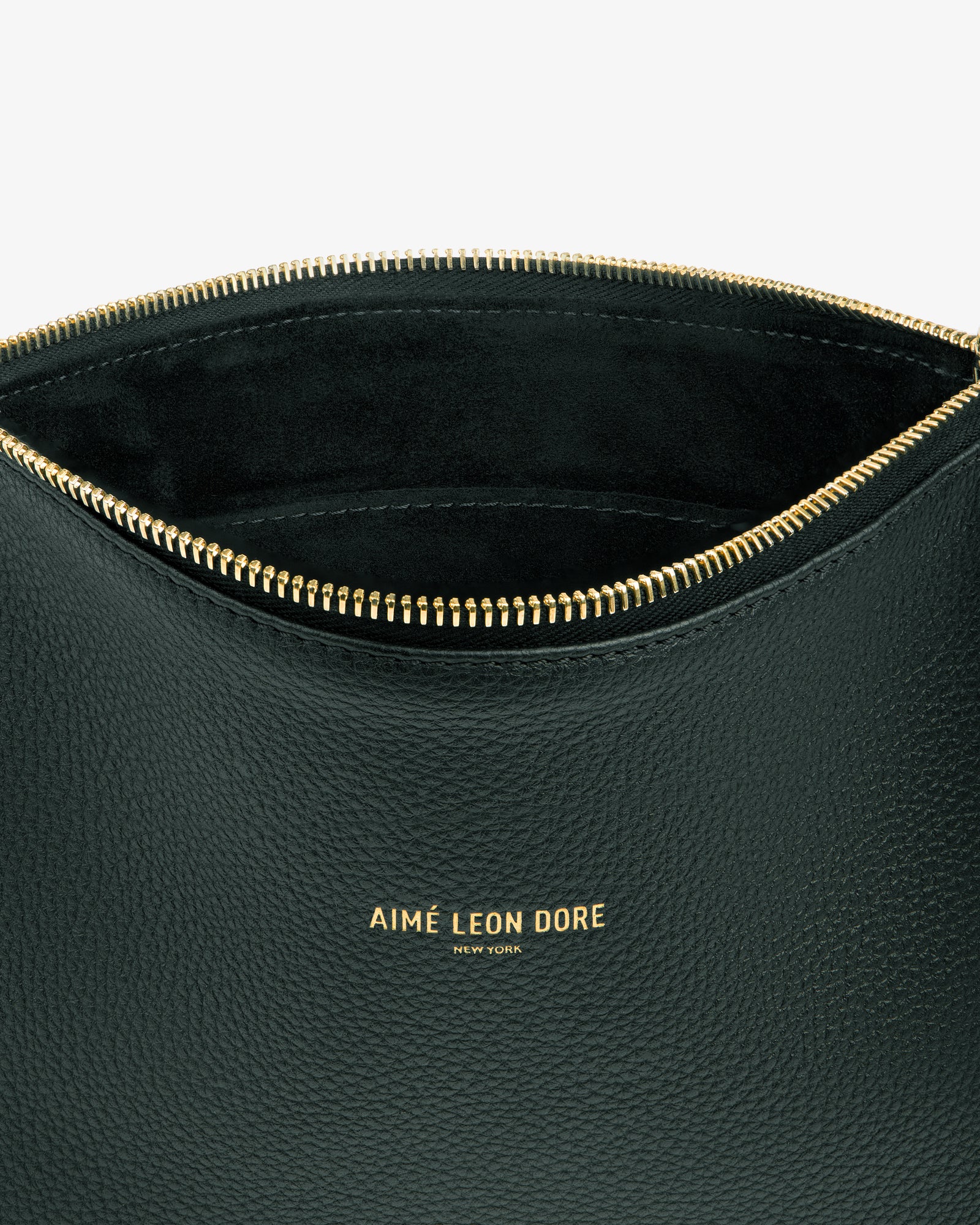 The Small Leather Pouch is black with a gold zipper and AIMÉ LEON DORE NEW YORK embossed in gold on the front.