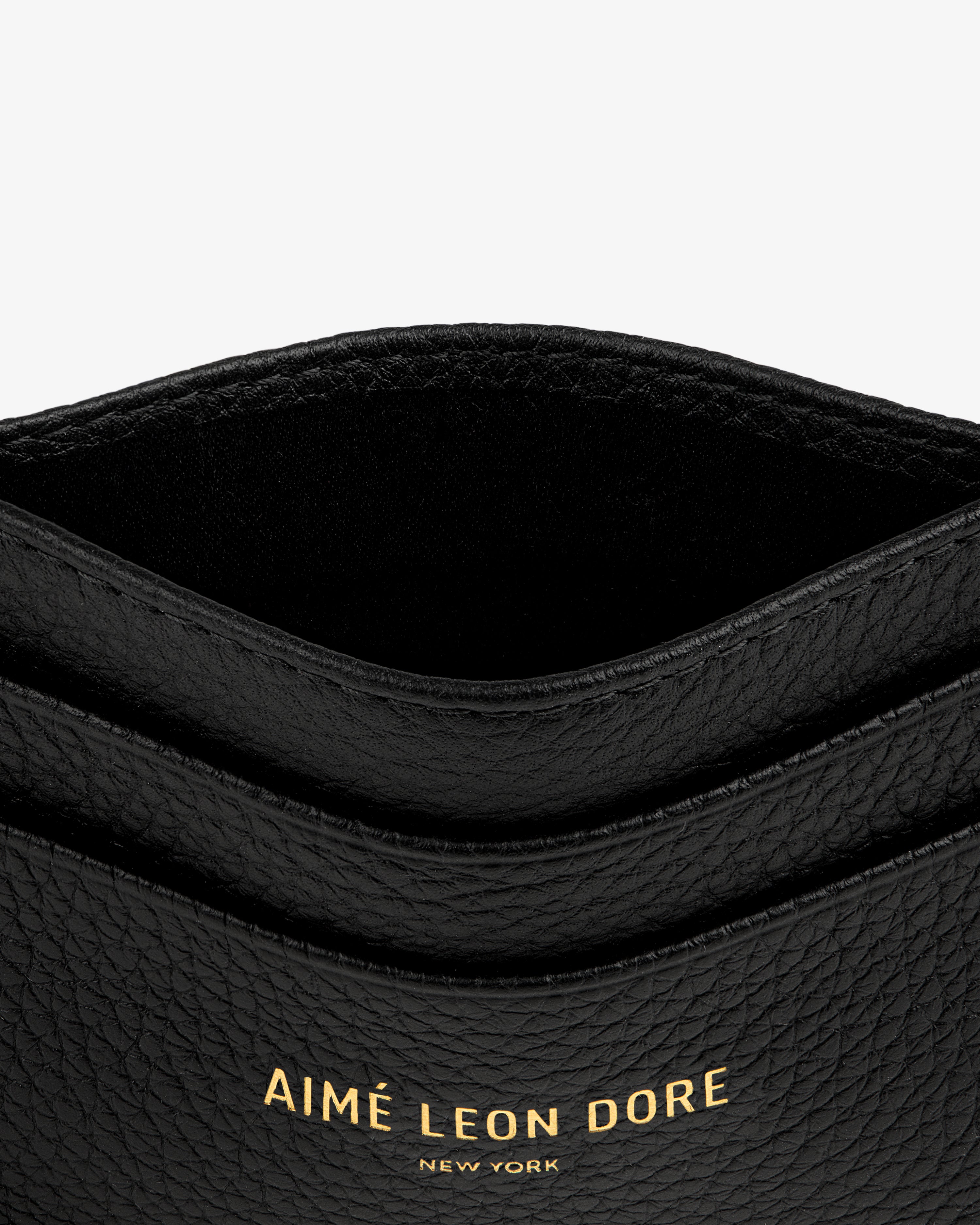Leather Card Holder in black with gold AIMÉ LEON DORE NEW YORK text embossed on the front.