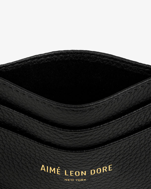 Leather Card Holder in black with gold AIMÉ LEON DORE NEW YORK text embossed on the front.