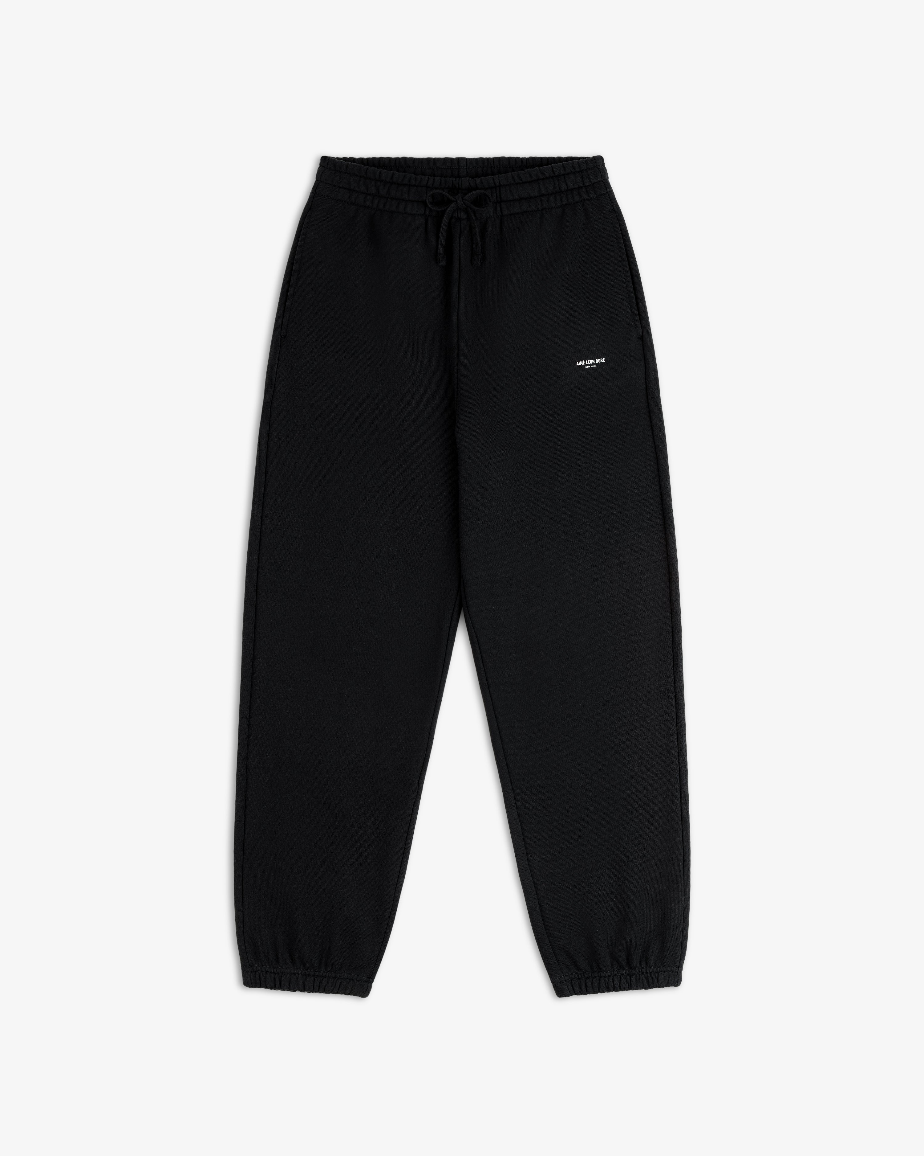 Micro Logo Sweatpants: black, elastic waist, drawstring, cuffed ankles, small white logo on left thigh.
