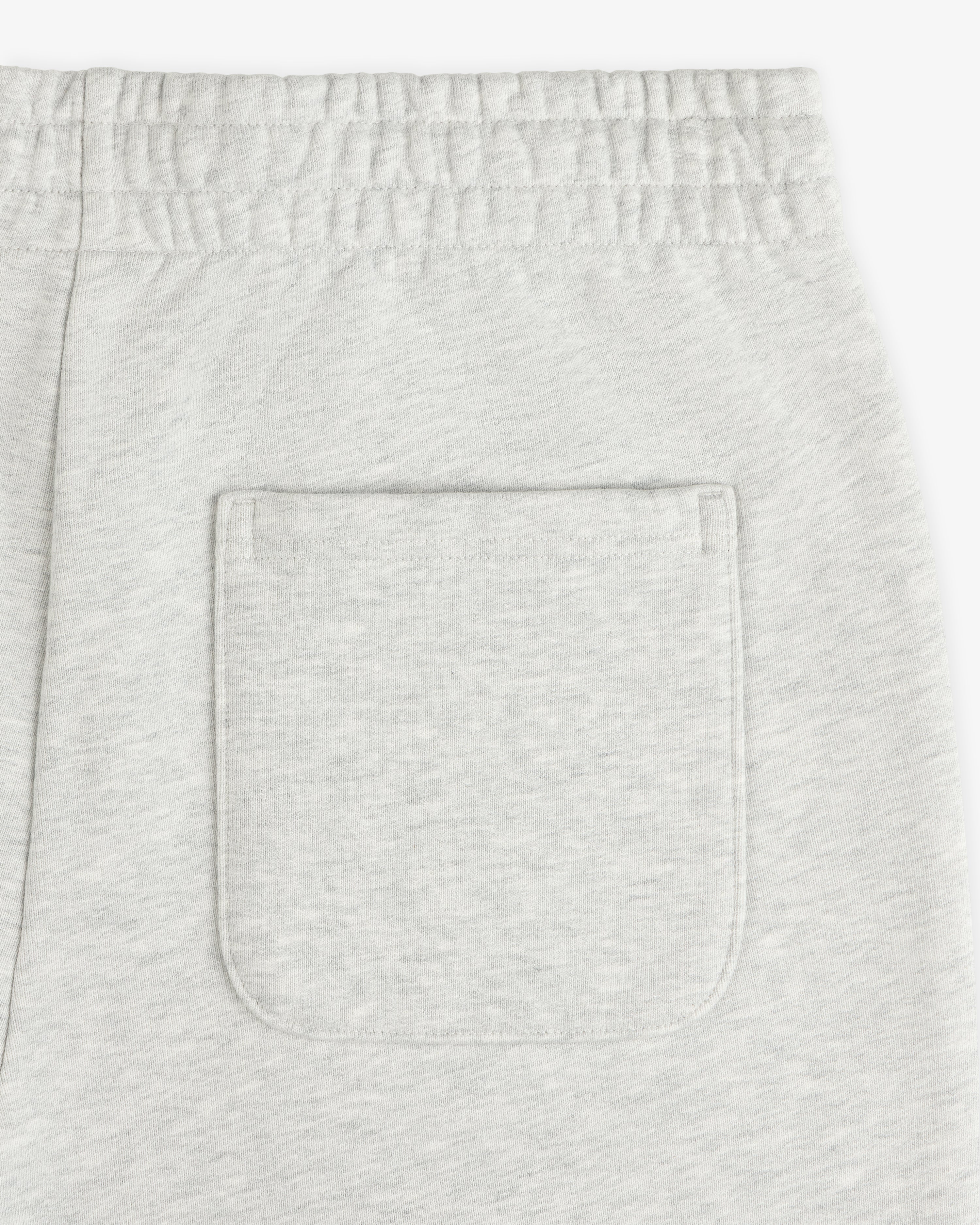 Detail of Micro Logo Sweatpants featuring light gray color, elastic waistband, and one back patch pocket.