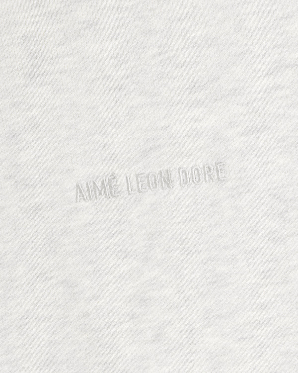 Close-up of Tonal Logo Crewneck Sweatshirt in light gray with AIMÉ LEON DORE subtly embossed at the center.
