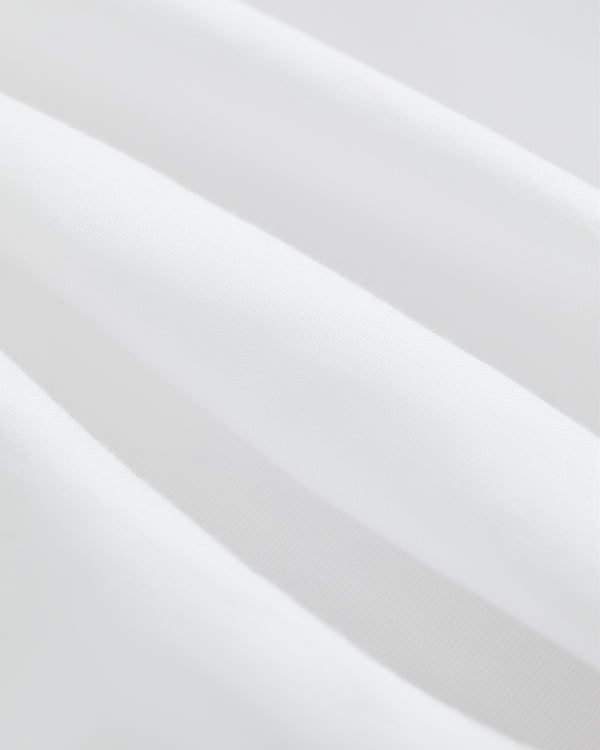 Close-up of soft, white T-Shirt 3-Pack fabric with gentle folds for a smooth, clean texture.