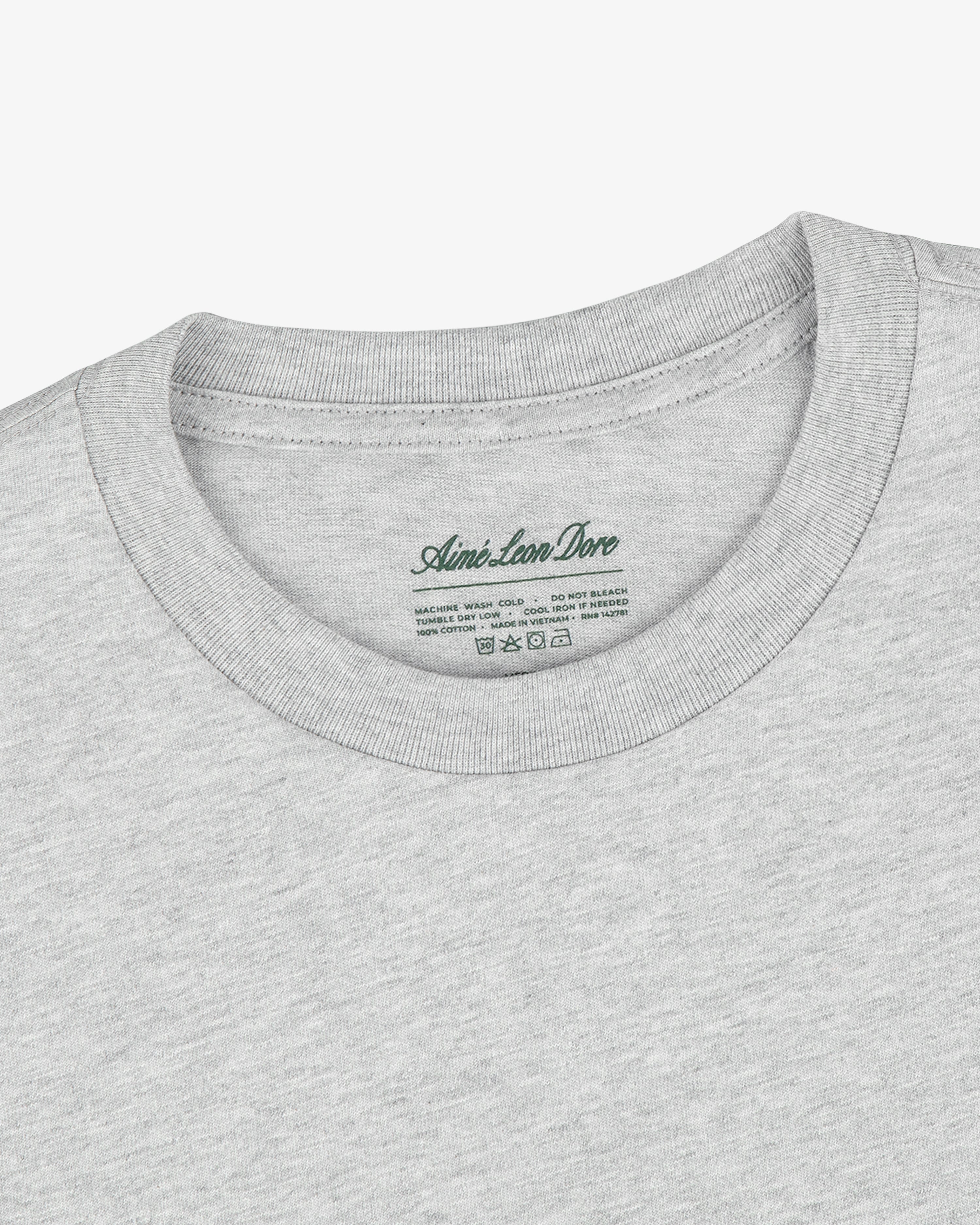 Close-up of a Multi-Color T-Shirt 3-Pack in light gray with Aimé Leon Dore label printed inside the collar.
