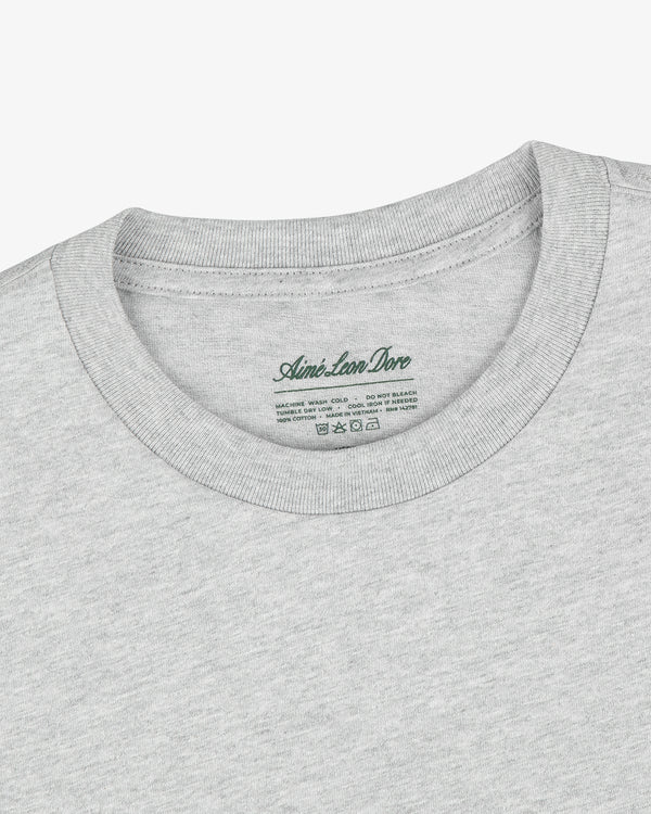 Close-up of a Multi-Color T-Shirt 3-Pack in light gray with Aimé Leon Dore label printed inside the collar.