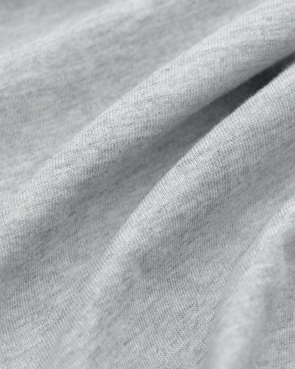 Close-up of light gray fabric from Multi-Color T-Shirt 3-Pack, with soft folds and a smooth, slightly textured surface.