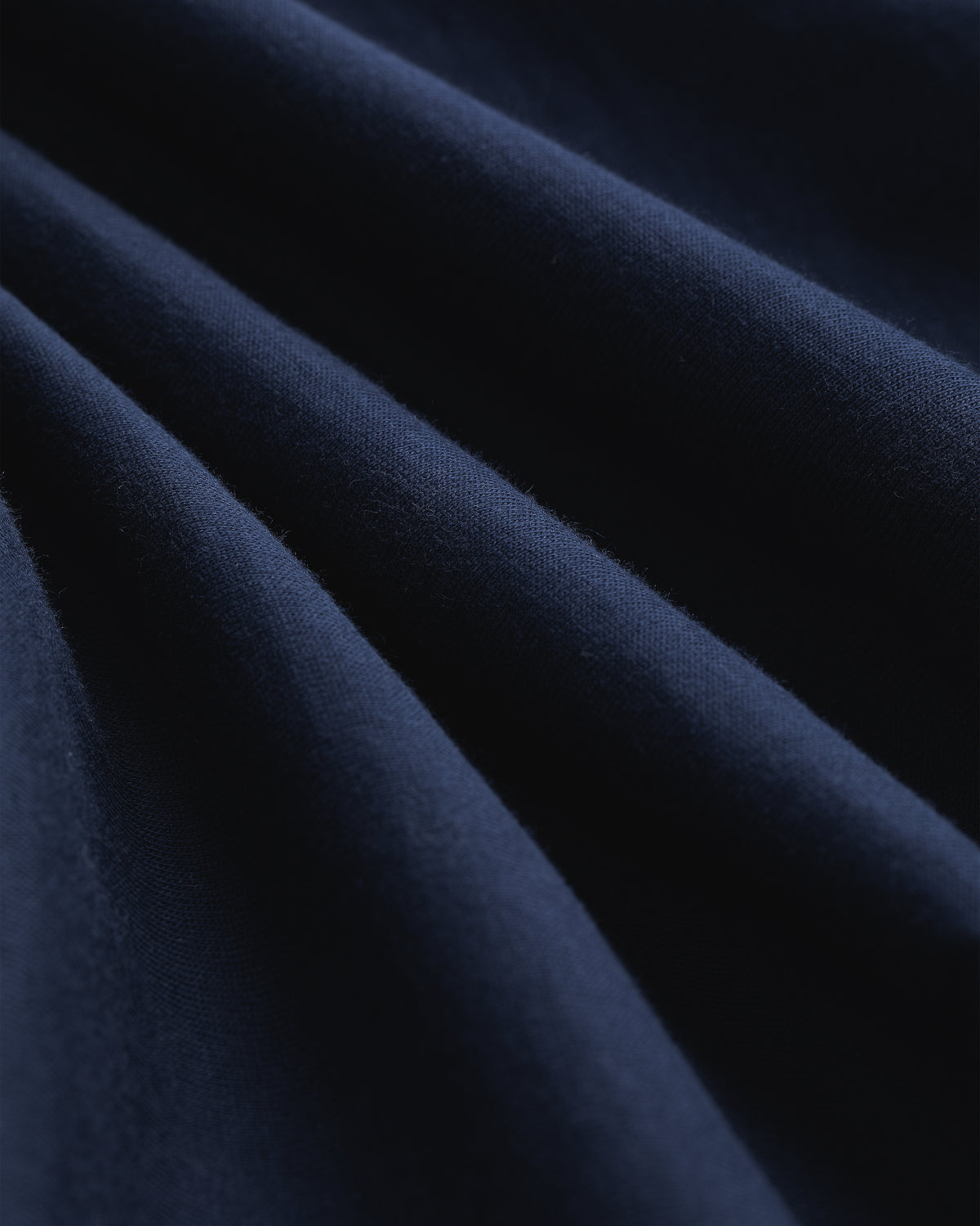 Close-up of Multi-Color T-Shirt 3-Pack fabric, showing soft folds, smooth texture, and gentle shadows.